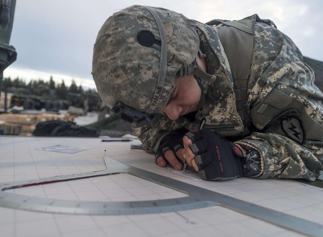 Army Spc. Brandon Rawlins writes down azimuths and coordinates before participating in a live-fire exercise on Joint Base Elmendorf-Richardson, Alaska, Jan. 11, 2016. Rawlins is assigned to the 25th Infantry Division’s 2nd Battalion, 377th Parachute Field Artillery Regiment, 4th Infantry Brigade Combat Team. U.S. Air Force photo by Justin Connaher