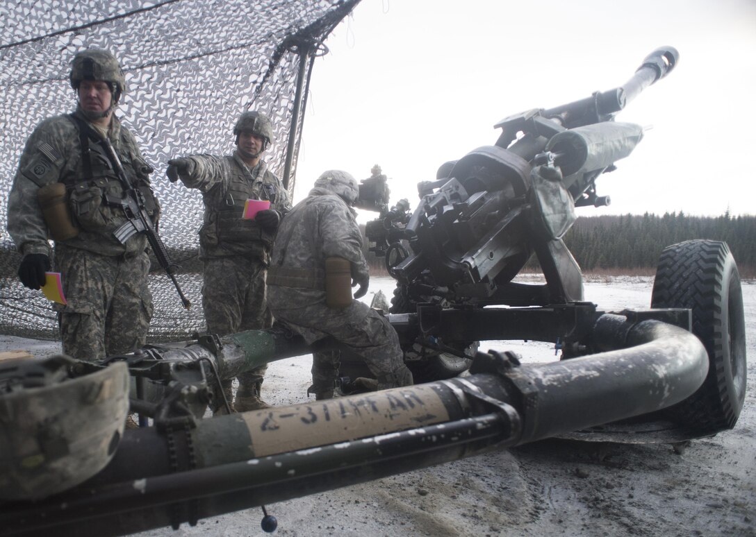 Army Staff Sgt. Scott Beardsley, left, and Sgts. Angel Salazar and Estevan Rodriguez prepare an M119A2 105 mm howitzer for a live-fire exercise on Joint Base Elmendorf-Richardson, Alaska, Jan. 11, 2016. Beardsley, Salazar and Rodriguez are assigned to the 25th Infantry Division’s 2nd Battalion, 377th Parachute Field Artillery Regiment, 4th Infantry Brigade Combat Team. U.S. Air Force photo by Justin Connaher