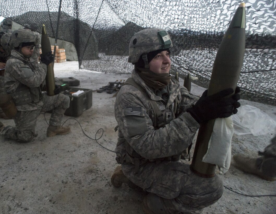 Army Pfc. Emilio Ojeda, left, and Spc. James Rolf wait for orders to load rounds and fire during a howitzer live-fire exercise on Joint Base Elmendorf-Richardson, Alaska, Jan. 11, 2016. Ojeda and Rolf are assigned to the 25th Infantry Division’s 2nd Battalion, 377th Parachute Field Artillery Regiment, 4th Infantry Brigade Combat Team. U.S. Air Force photo by Justin Connaher