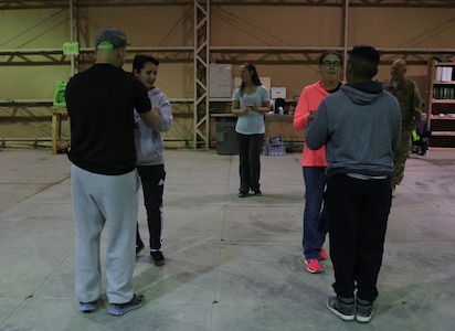 Washington Army National Guard Spc. Megan O'Malley, an automated logistics specialist in Company E, 1st Battalion, 168th Aviation Regiment, 40th Combat Aviation Brigade, teaches a ballroom dance class to her fellow Soldiers in Company E at Camp Buehring, Kuwait, Jan. 6, 2016. O'Malley planned to expand her class attendance to all Soldiers on the base interested in attending. 