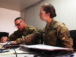 Washington National Guard Spc. Megan O’Malley, an automated logistics specialist, helps out in the office at Company E, 1st Battalion, 168th Aviation Regiment, 40th Combat Aviation Brigade, Camp Buehring, Kuwait, Dec. 29, 2015. O’Malley taught a ballroom dance class to her fellow Soldiers in the brigade. 
