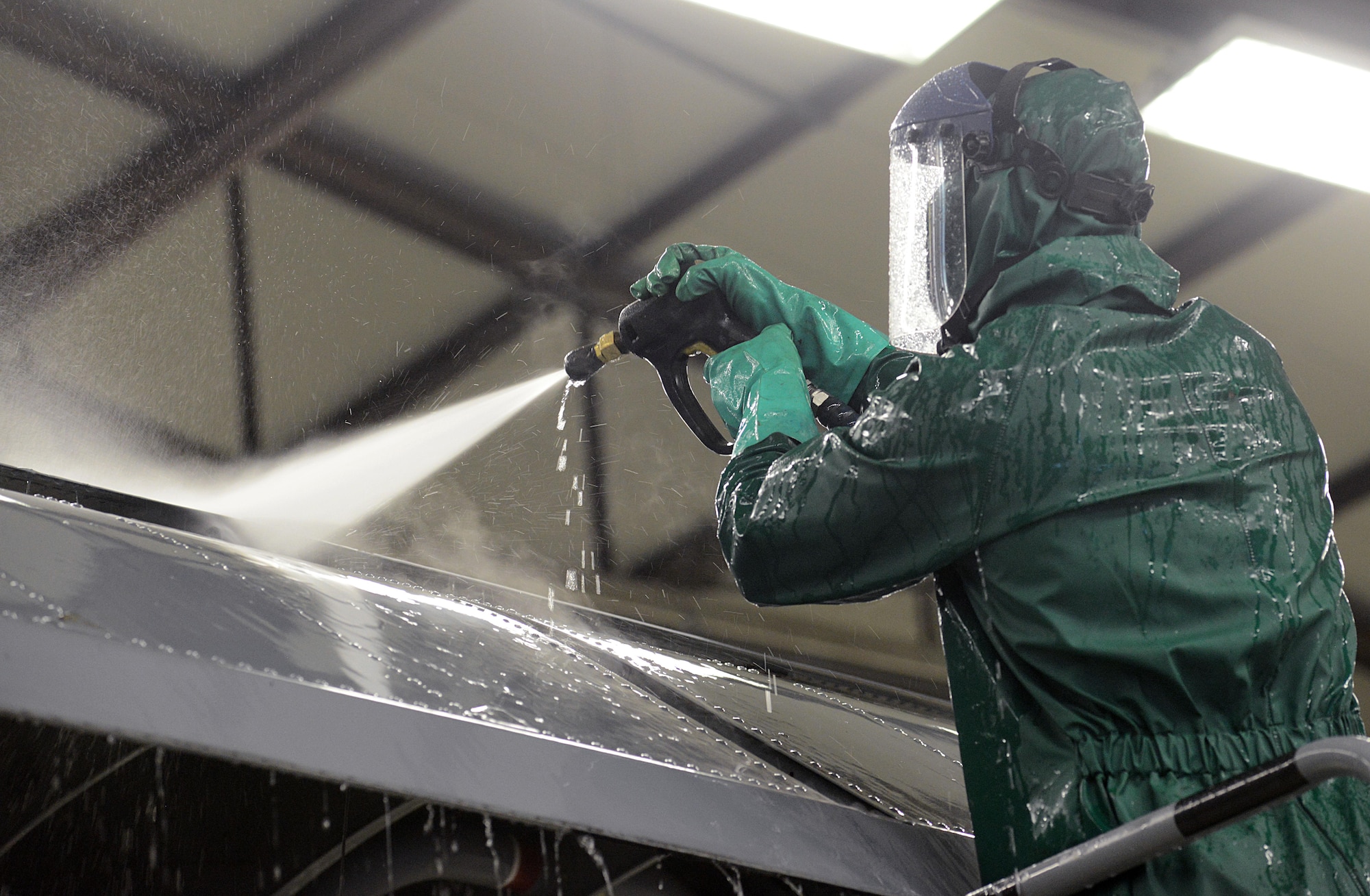 Airman Drew Thurau, an 86th Maintenance Squadron crew chief, sprays water on the wing of a C-130J Super Hercules during a pre-isochronal inspection wash Jan. 4, 2016, at Ramstein Air Base, Germany. An ISO inspection is a scheduled, extensive examination of an aircraft to maintain its functionality and perform preventive maintenance. (U.S. Air Force photo/Staff Sgt. Timothy Moore)