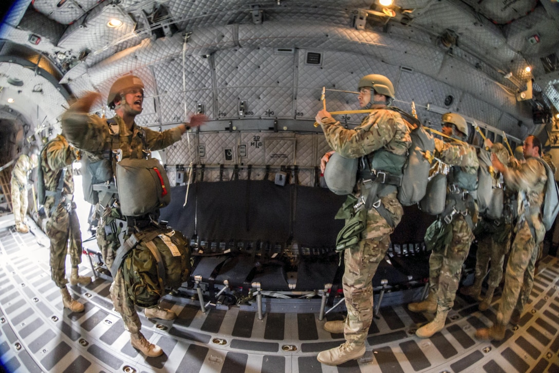 An Army jumpmaster commands equipment check during an airborne operation over Homestead Air Reserve Base, Fla., Jan. 12, 2016. Army photo by Staff Sgt. Osvaldo Equite