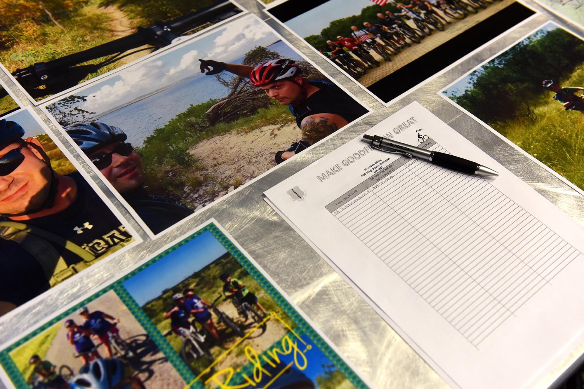Mountain biking photos surround a club sign-up sheet during the Make Goodfellow Great Kick-Off Party at the Event Center on Goodfellow Air Force Base, Texas, Jan. 14, 2016. The event consisted of several booths displaying various clubs available on base that individuals could sign up for. (U.S. Air Force photo by Senior Airman Devin Boyer/Released)