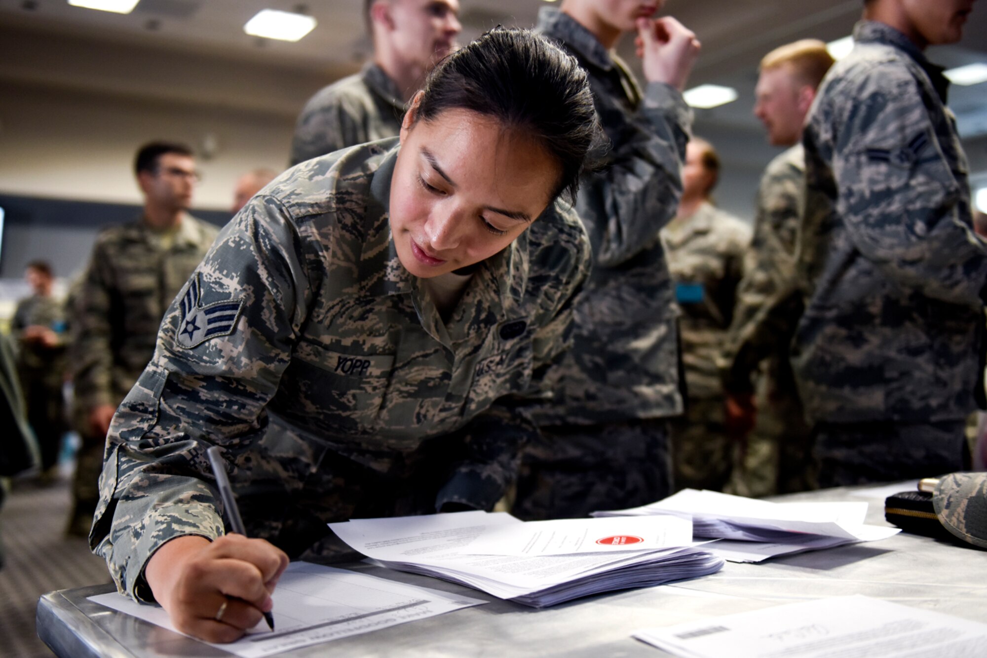 U.S. Air force Senior Airman Jill N. Yopp, 17th Communication Squadron network operations technician, signs up for a club during the Make Goodfellow Great Kick-Off Party at the Event Center on Goodfellow Air Force Base, Texas, Jan. 14, 2016. Make Goodfellow Great is a wing commander initiative to improve social interaction on base through various clubs that base members create. (U.S. Air Force photo by Senior Airman Devin Boyer/Released)