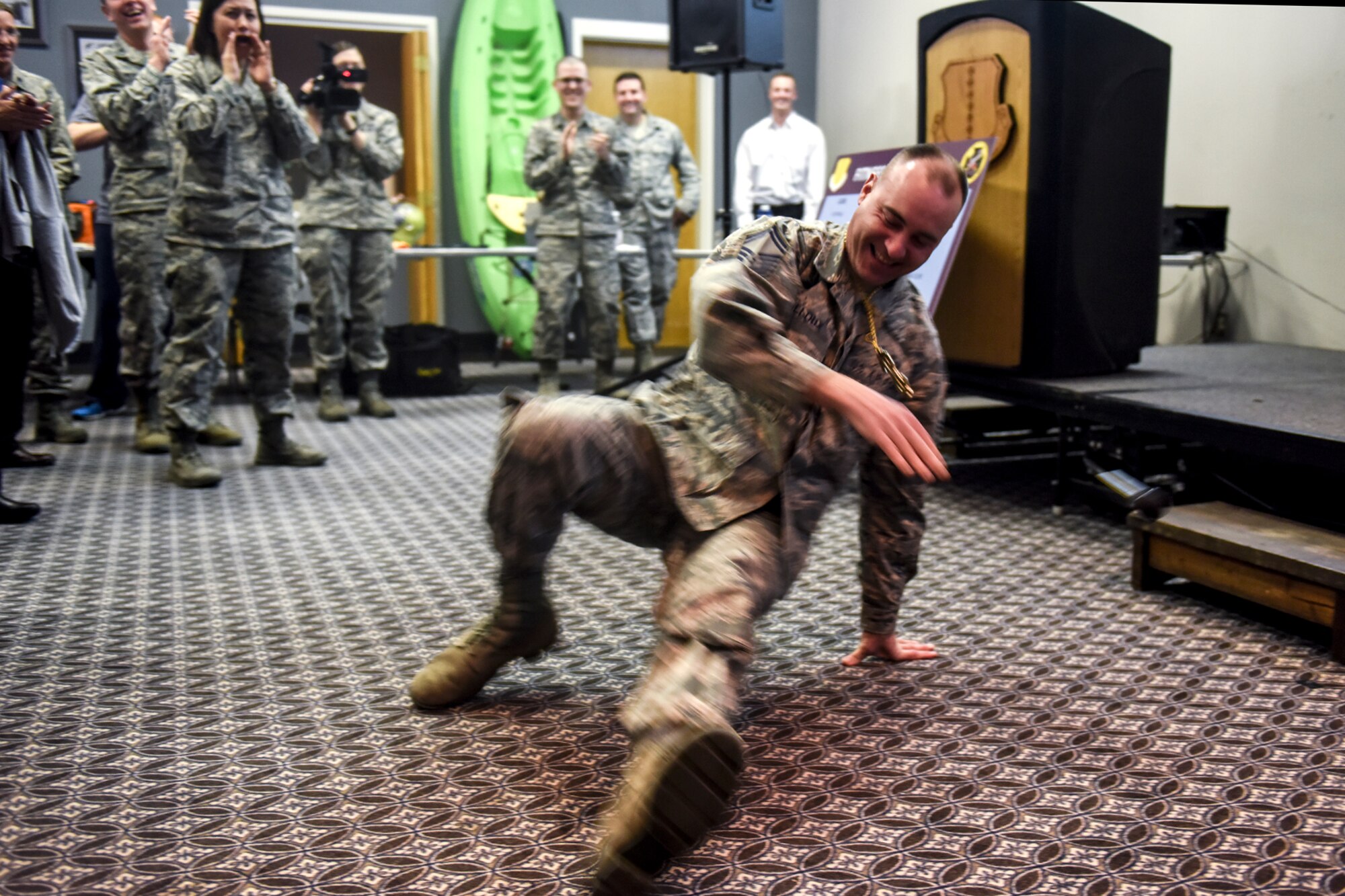 U.S. Air Force Senior Master Sgt. Brian P. Mailloux, 17th Comptroller Squadron superintendent, break dances during a lip syncing competition as part of the Make Goodfellow Great Kick-Off Party at the Event Center on Goodfellow Air Force Base, Texas, Jan. 14, 2016. The friendly competition was intended to promote the MGG initiative, a group of clubs meant to encourage social interaction. (U.S. Air Force photo by Senior Airman Devin Boyer/Released)