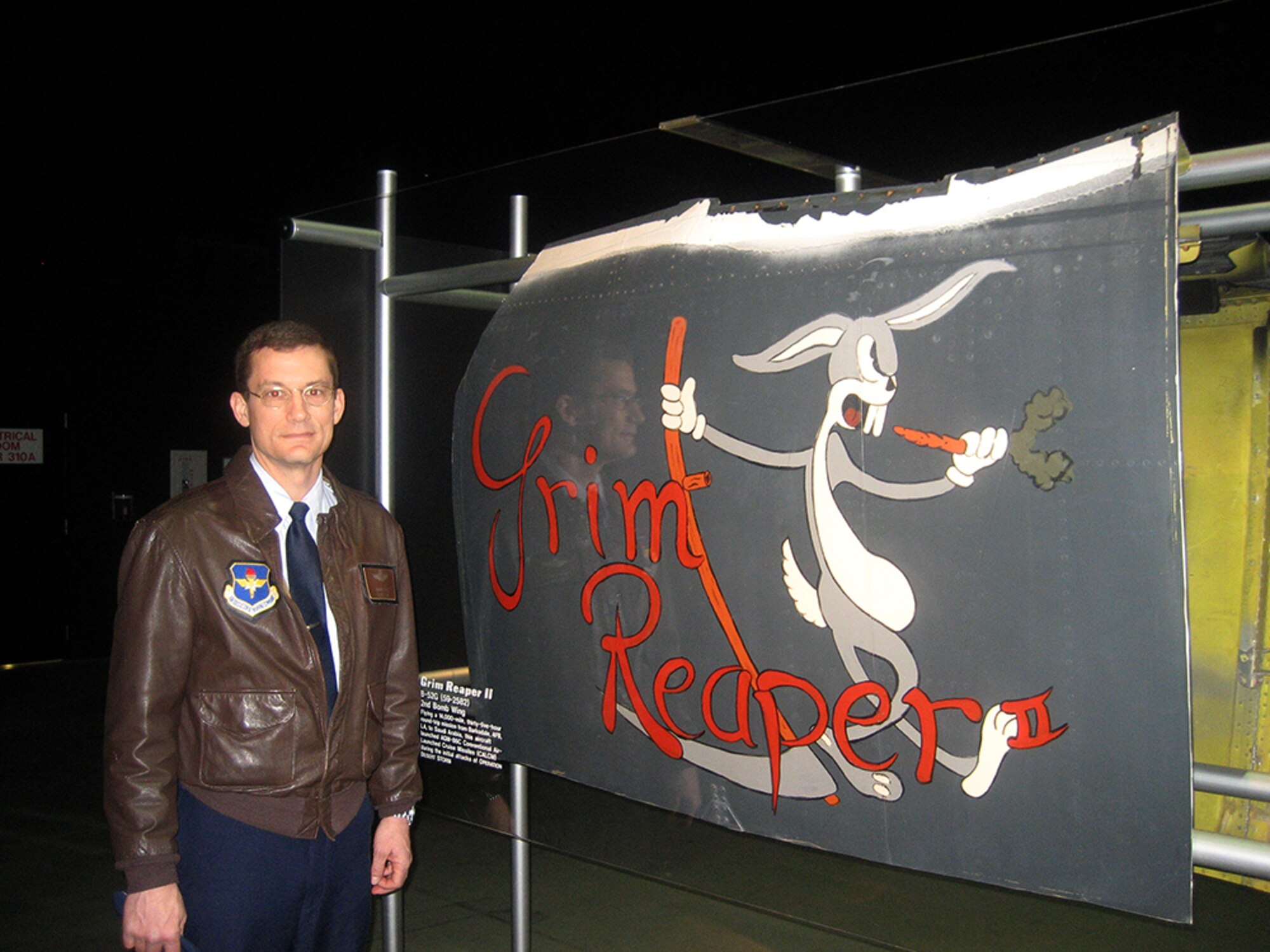 Warren Ward, deputy chief of programming division, Air Force Global Strike Command, stands next to the nose art on "Grim Reaper II," the B-52G he flew January 16, 1991, during Operation "Secret Squirrel." The aircraft was one of the seven strike aircraft used during the top secret mission. The original nose art was cut off and preserved, and is now on display at the National Museum of the United States Air Force at Wright-Patterson Air Force Base, Ohio. (Courtesy photo)
