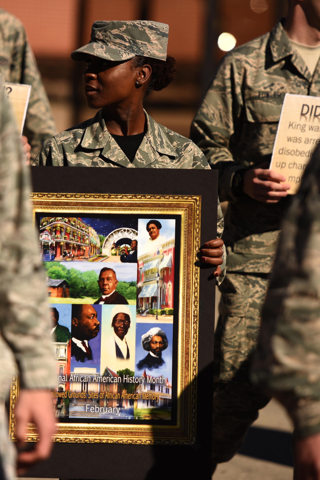 U.S. Air Force Tech. Sgt. Curtrell Gibson, 17th Training Wing Airman Leadership School Instructor, holds a sign during a march on Goodfellow Air Force Base, Texas, Jan. 15, 2016. The event commemorated the marches Martin Luther King Jr. and his supporters led during the civil rights movement. (U.S. Air Force photo by Senior Airman Scott Jackson/Released)