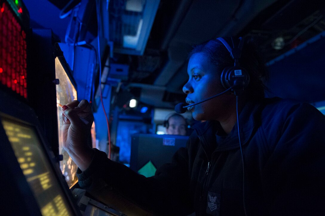 U.S. Navy Petty Officer 1st Class J. Camp writes on a screen during anti-submarine tactical air controller watch aboard the guided-missile destroyer USS Gravely in the Gulf of Oman, Jan. 11, 2016. The Gravely is deployed with the Harry S. Truman Carrier Strike Group, supporting maritime security operations and theater security cooperation in the U.S. 5th Fleet area of operations. U.S. Navy photo by Petty Officer 2nd Class Darby C. Dillon