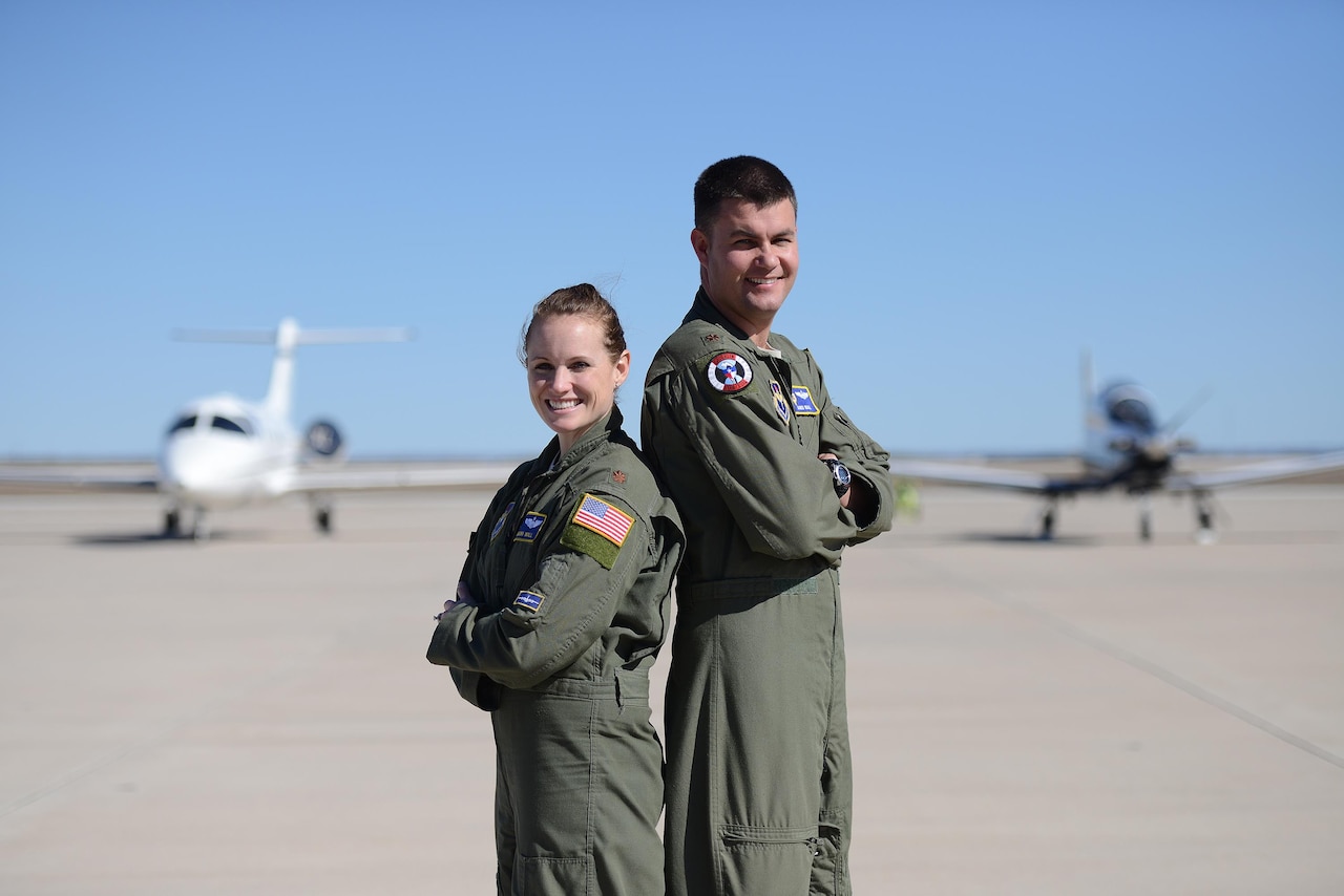 Maj. Regina Wall, 86th Flying Training Squadron assistant director of operations, and Maj. Jared Wall, 47th Operations Group T-6A Texan II standardization and evaluation branch chief, pose for a photo on Laughlin Air Force Base, Texas, Jan. 15, 2016. Although moving from base to base, deploying and working long and erratic hours for more than 10 years, the Walls and their two children have found a balance in the military and their personal lives. (U.S. Air Force photo by Airman 1st Class Brandon May)(U.S. Air Force photo by Airman 1st Class Brandon May)