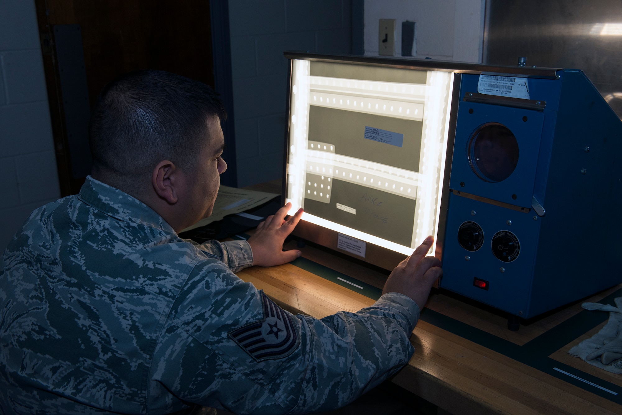 U.S. Air Force Tech. Sgt. Adrian Castillo, 23d Equipment Maintenance Squadron non-destructive inspection unit fabrication flight section chief, examines a laser spot tracker part for defects, Jan. 12, 2016, at Moody Air Force Base, Ga. The unit ensures the structural integrity for all of Moody’s aircraft and support equipment utilizing equipment valued at approximately $1.1 million. (U.S. Air Force photo by Airman 1st Class Greg Nash/Released)