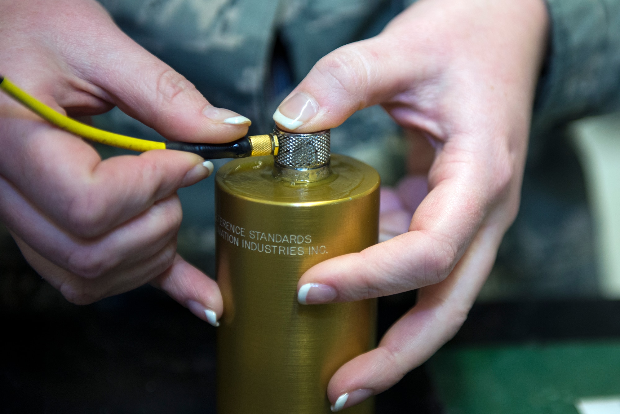 U.S. Air Force Airman 1st Class Brittany Fore, 23d Equipment Maintenance Squadron non-destructive inspection unit fabrication flight journeyman, checks for defects in a calibration block, Jan. 12, 2016, at Moody Air Force Base, Ga. Fore uses ultrasonic couplant which is designed to help the ultrasonic system listen for sound disruptions to determine if there’s a defect. (U.S. Air Force photo by Airman 1st Class Greg Nash/Released)  