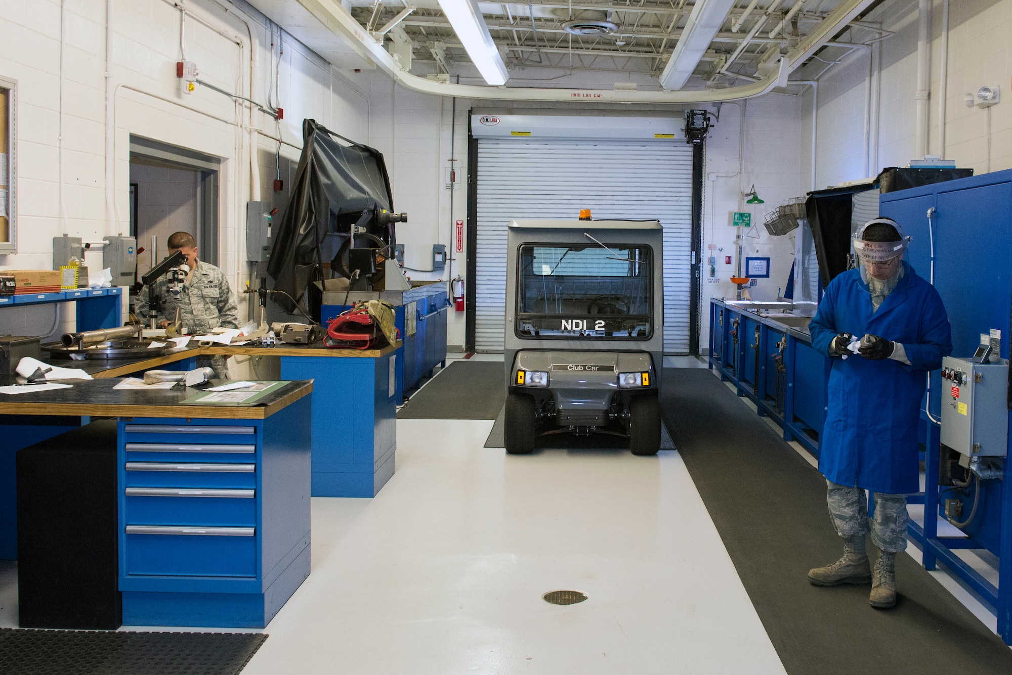 U.S. Air Force Tech. Sgt. Adrian Castillo, 23d Equipment Maintenance Squadron non-destructive inspection fabrication flight section chief, left, views samples in a microscope as Airman 1st Class Tony Alvizuri, 23d EMS NDI fabrications flight journeyman, prepares a tool for a black lighting inspection, Jan. 12, 2016, at Moody Air Force Base, Ga.  Approximately 20 personnel assigned to the unit detect discrepancies in Moody’s aircraft and support equipment. (U.S. Air Force photo by Airman 1st Class Greg Nash/Released) 