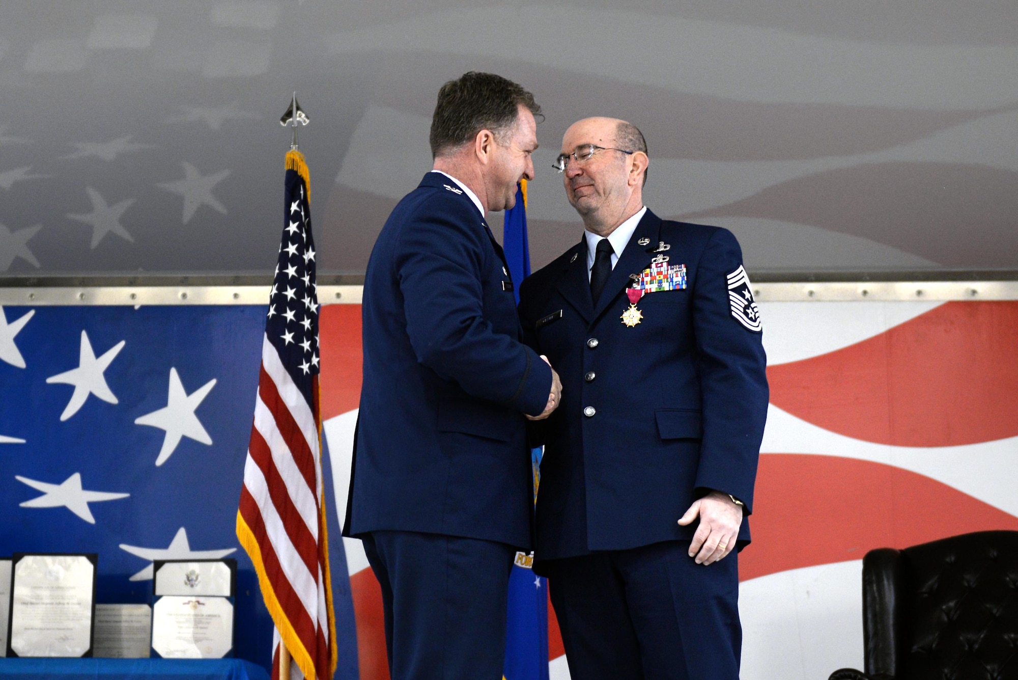 Col. Mark Slocum, 4th Fighter Wing commander, shakes hands with Chief Master Sgt. Jeffrey Craver, 4th Fighter Wing command chief, during Craver’s retirement ceremony, Jan. 15, 2016, at Seymour Johnson Air Force Base, North Carolina. Craver served in various leadership positions over his 30 years of service. (U.S. Air Force photo/Airman 1st Class Ashley Williamson)