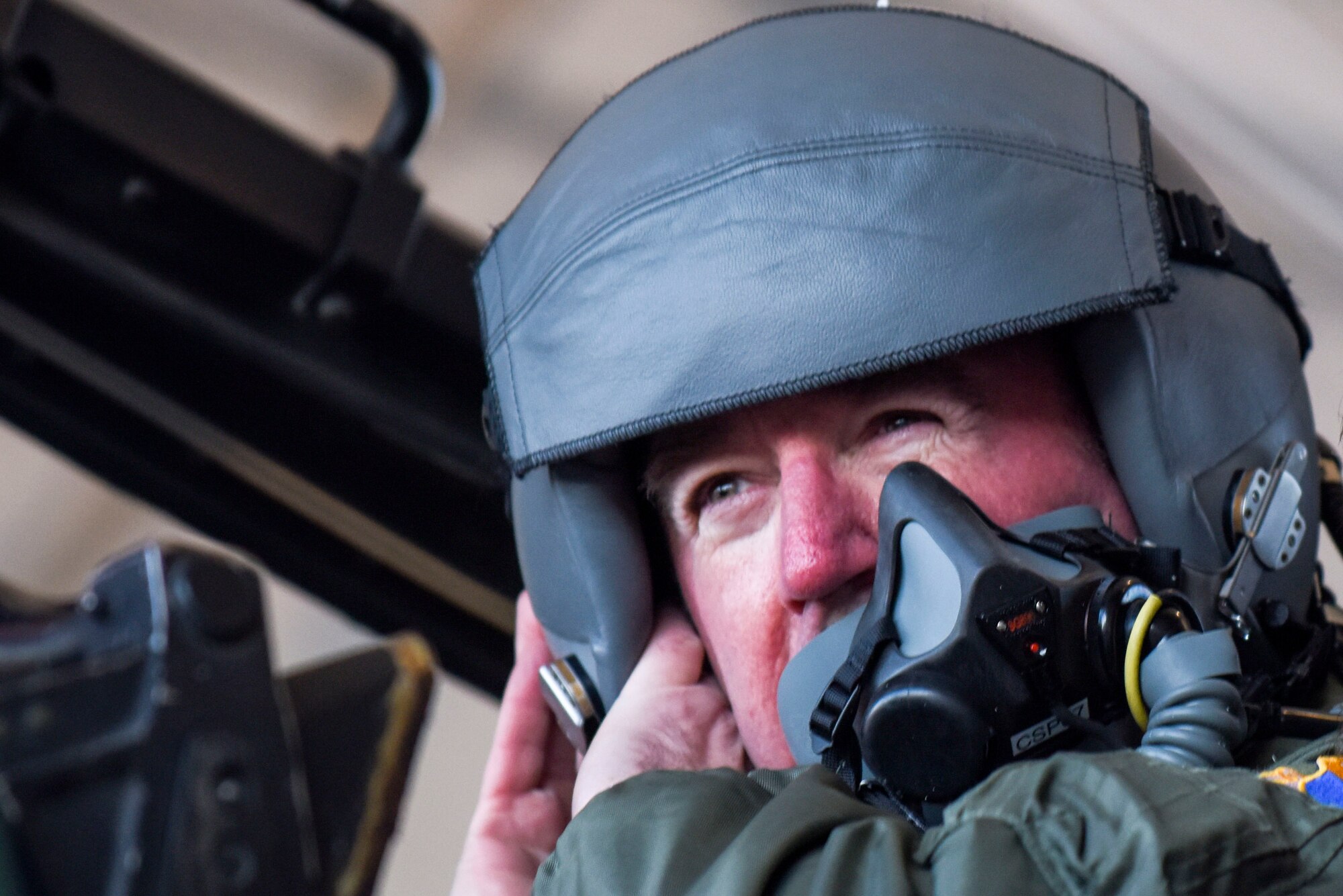 Chief Master Sgt. Jeffrey Craver, 4th Fighter Wing command chief, secures his helmet for a familiarization flight, Jan. 14, 2016, at Seymour Johnson Air Force Base, North Carolina. Col. Mark Slocum, 4th FW commander, flew Craver in an F-15E Strike Eagle following 30 years of service to the Air Force. (U.S. Air Force photo/Airman Shawna L. Keyes)