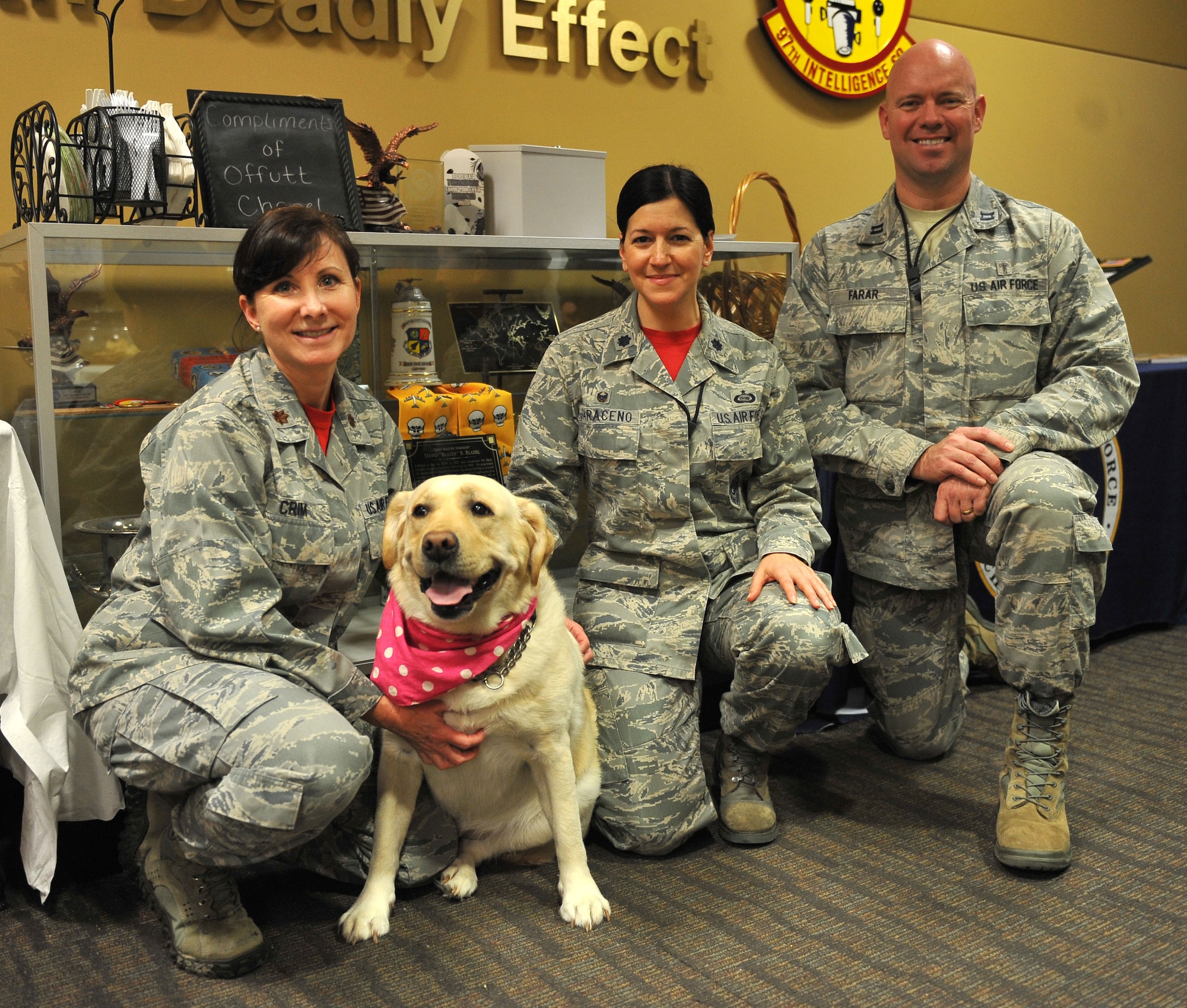 Maj. Shauna Crim, the mental health flight commander with the 55th Medical Operations Group, left, and her therapy dog, Lily, Lt. Col. Jennifer Saraceno, commander of the 97th Intelligence Squadron and Capt. Michael Farar, a chaplain with the 55th Wing Chaplain Corps attend the open house for the new mental health and chaplains' office within the secure area of the 97th IS at Offutt Air Force Base, Neb., Jan. 8, 2016. Crim and Farar will be manning the office, which was created to give Airmen a secure location in which to share potentially classified concerns with chaplains and mental health services. (U.S. Air Force photo/Senior Airman Rachel Hammes)