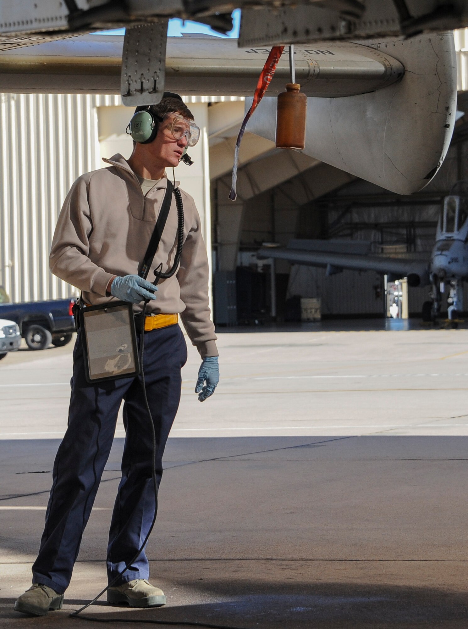 U.S. Air Force Airmen Benjamin Vance, 355th Aircraft Maintenance Squadron crew chief, drains fuel from an A-10C Thunderbolt II during the Cactus Flag exercise at Davis-Monthan Air Force Base, Ariz., Jan. 12, 2016. The 355th AMXS trained for high tempo aircraft operations in a simulated deployed environment. (U.S. Air Force photo by Airmen 1st Class Ashley N. Steffen/Released)