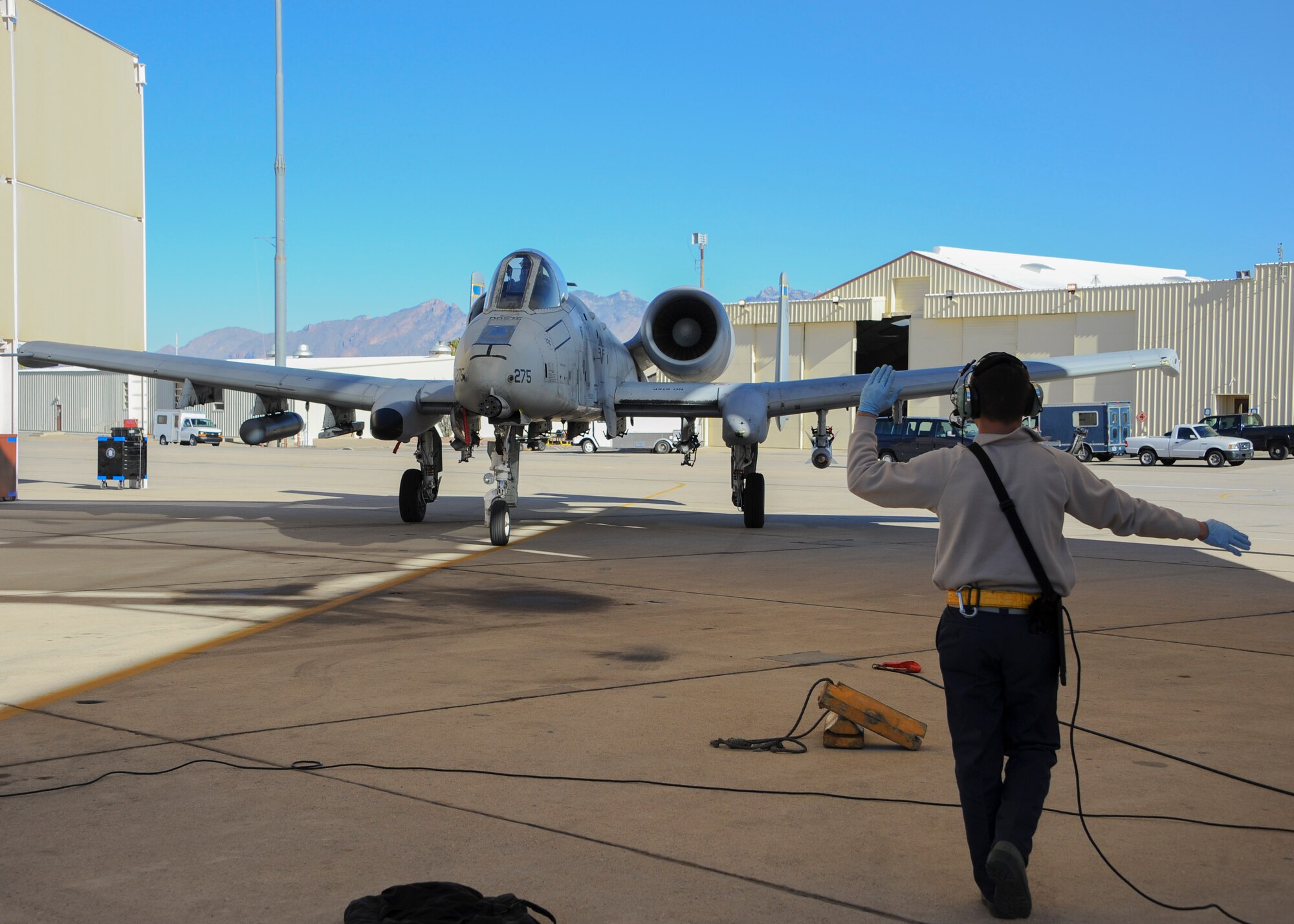 U.S. Air Force Airmen Benjamin Vance, 355th Aircraft Maintenance Squadron crew chief, marshals an A-10C Thunderbolt II during the Cactus Flag exercise at Davis-Monthan Air Force Base, Ariz., Jan. 12, 2016. The exercise assessed ability to support and conduct combat operations and integrate tactically in real world operations. (U.S. Air Force photo by Airmen 1st Class Ashley N. Steffen/Released)