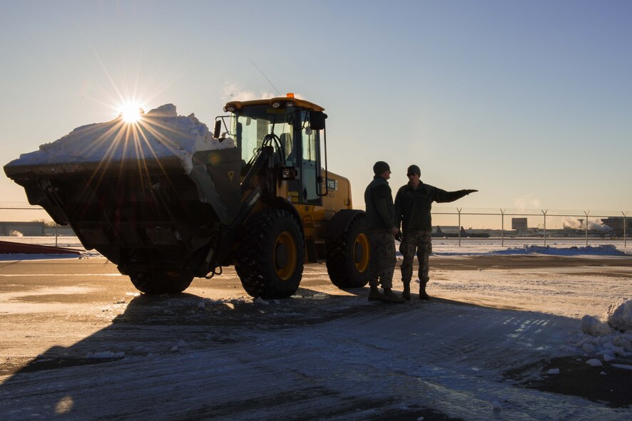 Senior Airman Jacob Pepper, right, speaks to Staff Sgt. Eric Tegels, 934th Civil Engineer Squadron technician, about installation snow removal on Jan. 10.  (U.S. Air Force Photo by Staff Sgt. Trevor Saylor)