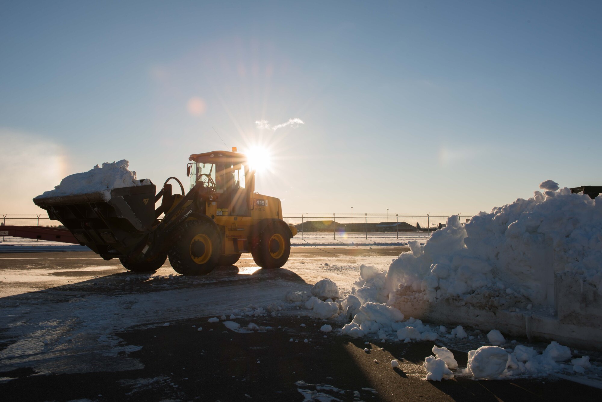 Senior Airman Jacob Pepper, 934th Civil Engineer Squadron technician, uses a front-end loader to clear snow from a parking lot at the Minneapolis-St. Paul Air Reserve Station on Jan. 10  (U.S. Air Force Photo by Staff Sgt. Trevor Saylor)