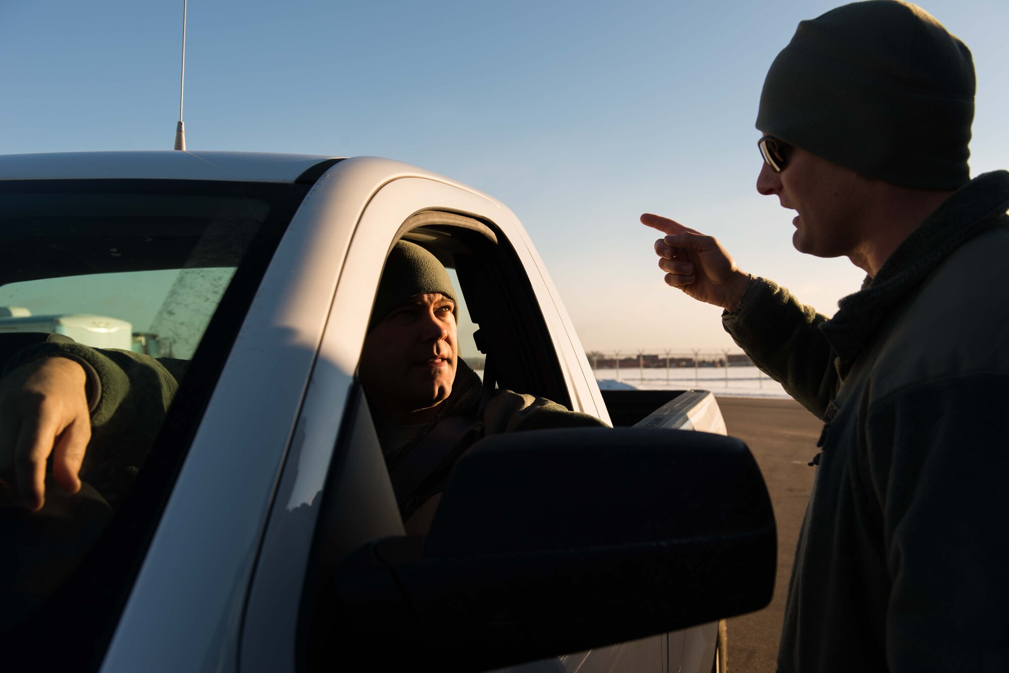 Tech. Sgt. Adam Ruter, 934th Civil Engineer Squadron technician (left), speaks to Staff Sgt. Eric Tegels about snow removal at the Minneapolis-St.Paul Air Reserve Station on Jan. 10 (U.S. Air Force photo by SSgt Trevor Saylor)