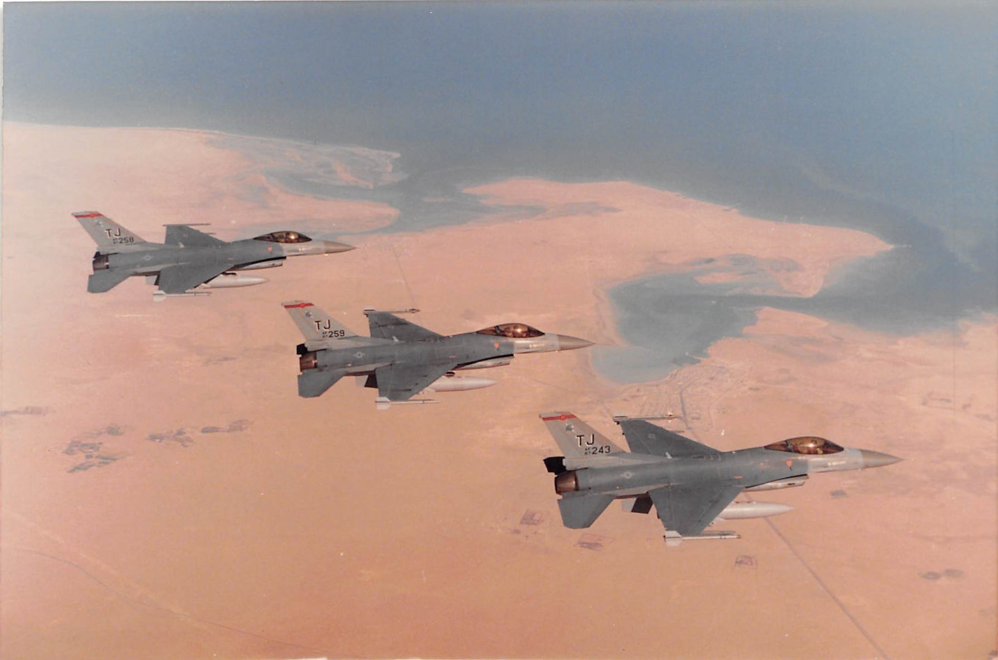 Col. Bruce “Baghdad” Cox, 307th Bomb Wing commander, Barksdale Air Force Base, La., flies his F-16 Fighting Falcon in formation with two other jets in Southwest Asia during operations Desert Shield and Desert Storm. Cox flew in the first daylight raid over Baghdad in January 1991 and was assigned here to the 457th Fighter Squadron after the conflict. (U.S. Air Force photo courtesy of Col. Bruce Cox)