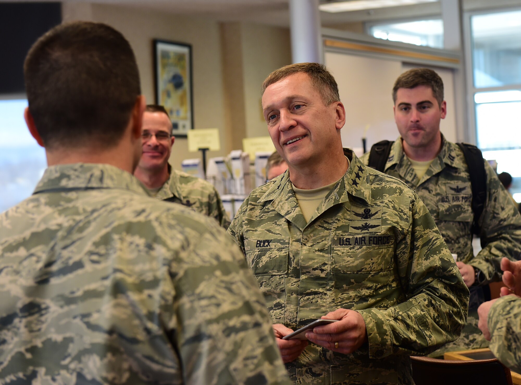 Lt. Gen. David J. Buck, Commander, 14th Air Force (Air Forces Strategic), Air Force Space Command; and Commander, Joint Functional Component Command for Space, U.S. Strategic Command, talks with Col. John Wagner, 460th Space Wing commander, Jan. 14, 2016, at Buckley Air Force Base, Colo. after his helicopter tour around the base. Buck visited base facilities and met with members of Team Buckley to discuss the 460th Space Wing mission. (U.S. Air Force photo by Airman 1st Class Gabrielle Spradling)