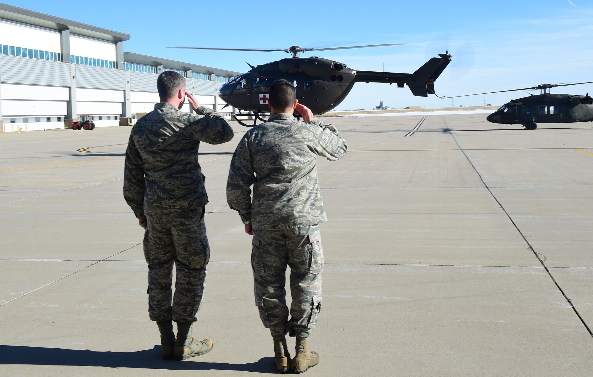 Col. John Wagner, 460th Space Wing commander, and Capt. Daniel Boyd, 14th Air Force commander’s aide, salute as Lt. Gen. David J. Buck, Commander, 14th Air Force (Air Forces Strategic), Air Force Space Command; and Commander, Joint Functional Component Command for Space, U.S. Strategic Command, takes off for a helicopter tour of base Jan. 14, 2016, at Buckley Air Force Base, Colo. Buck visited base facilities and met with members of Team Buckley to discuss the 460th Space Wing mission. (U.S. Air Force photo by Airman 1st Class Gabrielle Spradling)
