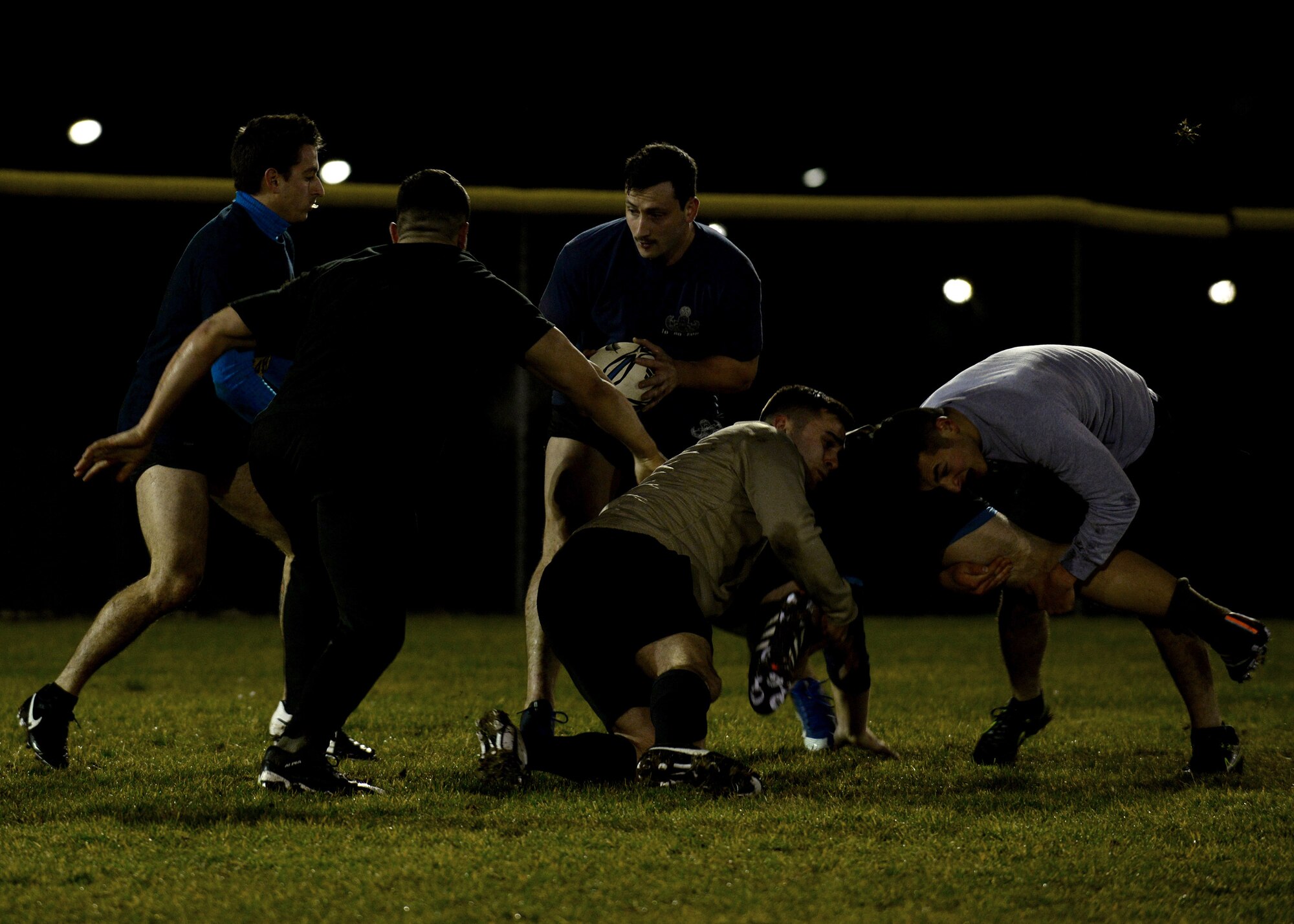 U.S. Air Force Airmen run offensive and defensive drills during rugby practice, Jan. 12, 2016, at Aviano Air Base, Italy. The team will compete against local Italian rugby teams and possibly teams throughout Europe. (U.S. Air Force photo by Airman 1st Class Cary Smith/Released)