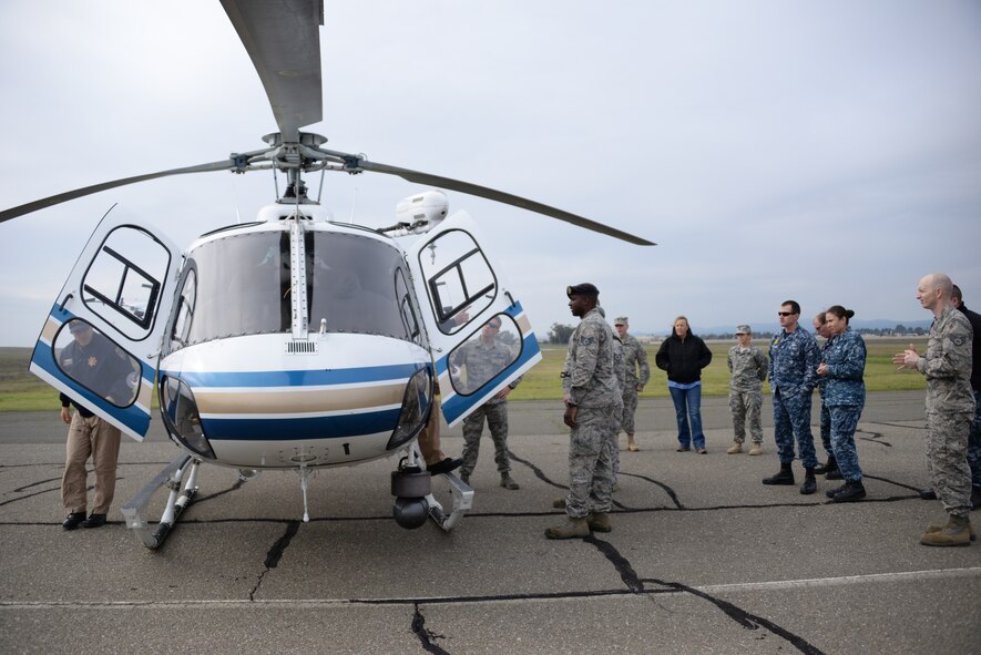 The 60th Security Forces Squadron participate in joint training Jan. 11 at Travis Air Force Base, California, with the California Highway Patrol. The training was to familiarize the military working dogs and their handlers with loading and unloading procedures using a helicopter. (U.S. Air Force photo by Airman 1st Class Amber Carter)