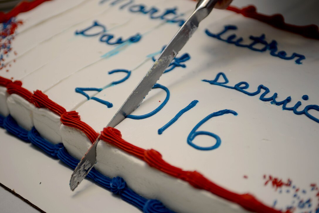 A cake cutting ceremony is performed for Martin Luther King, Jr. Day of Observance at Ellsworth Air Force Base, S.D., Jan. 12, 2016. The Diversity Council recognized the holiday to motivate Airmen to embrace diversity and community service. For more information about the council, call (605) 385-1342. (U.S. Air Force photo by Airman Sadie Colbert/Released)