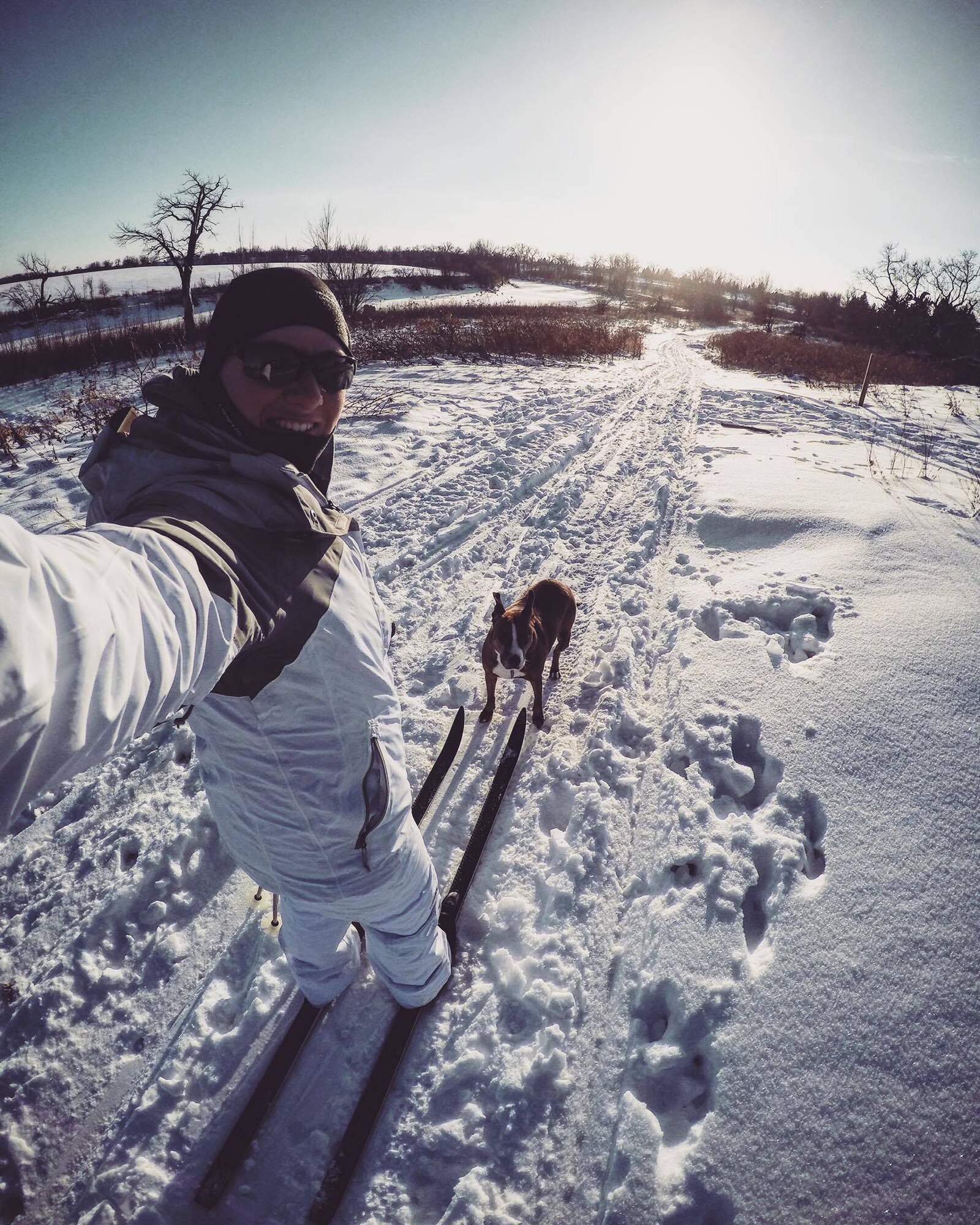 Senior Airman Sara Yandell, 319th Security Forces Squadron military working dog handler, cross-country skis with her dog Roxi by her side at The Greenway in Grand Forks, North Dakota. Yandell describes herself as an “outdoorsy” person, and reassures others who come to Grand Forks that there is plenty here to keep them busy. (Courtesy photo taken by Senior Airman Sara Yandell)