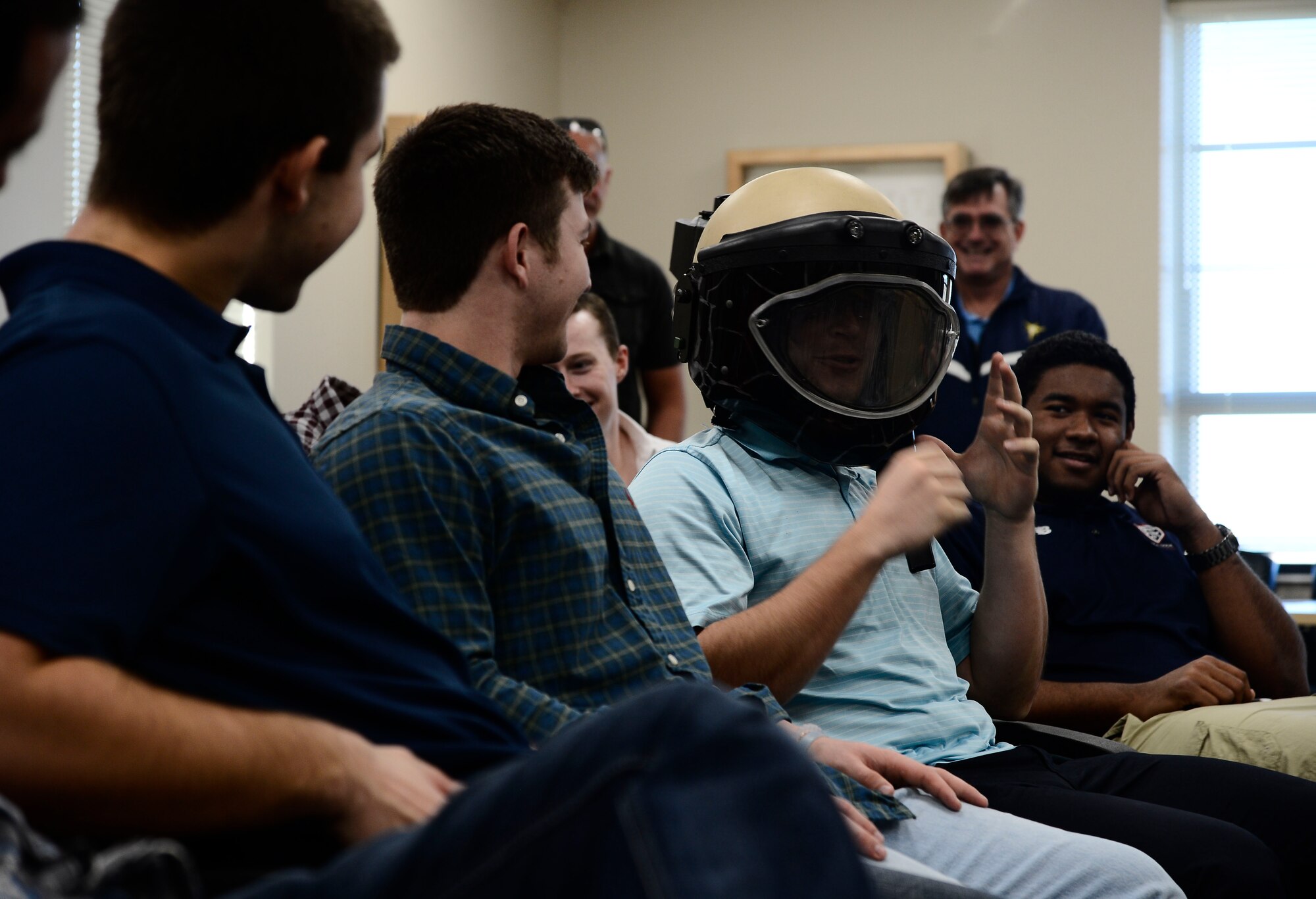 Brandon Lowe, a rookie with the Tampa Bay Rays, tries on a bomb helmet during a base tour at MacDill Air Force Base, Fla., Jan. 12, 2016. During the tour, the Rays stopped by military working dogs, explosive ordnance disposal, and the air traffic control tower to gain a better understanding of the teamwork that goes into accomplishing the base’s mission. (U.S. Air Force photo by Senior Airman Tori Schultz)
