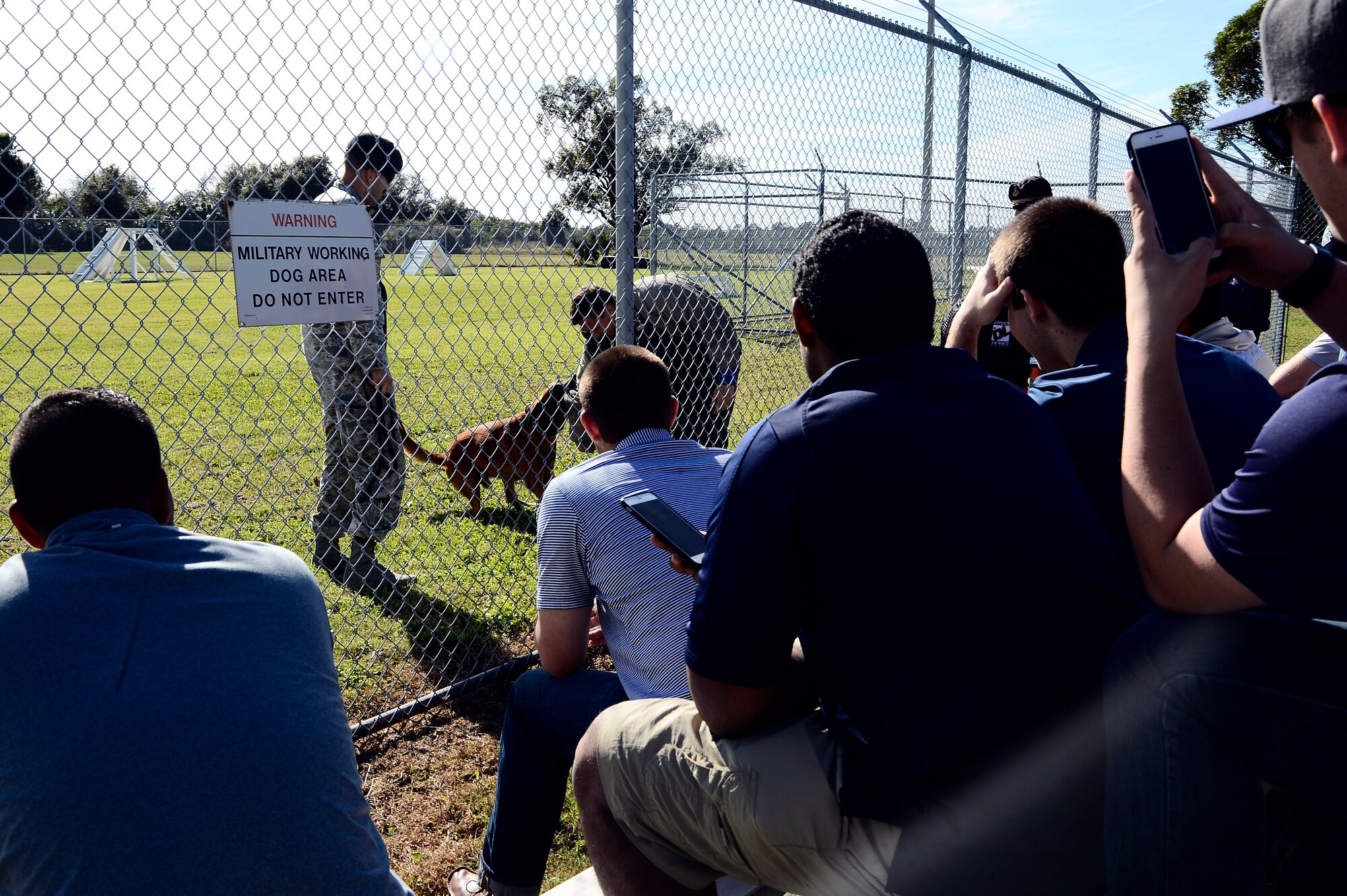 Rookies from the Tampa Bay Rays observe a military working dog demonstration during a tour at MacDill Air Force Base, Fla., Jan. 12, 2016. Players and staff from the Rays spent the afternoon with Airmen to get an inside look at MacDill’s mission. (U.S. Air Force photo by Senior Airman Tori Schultz)