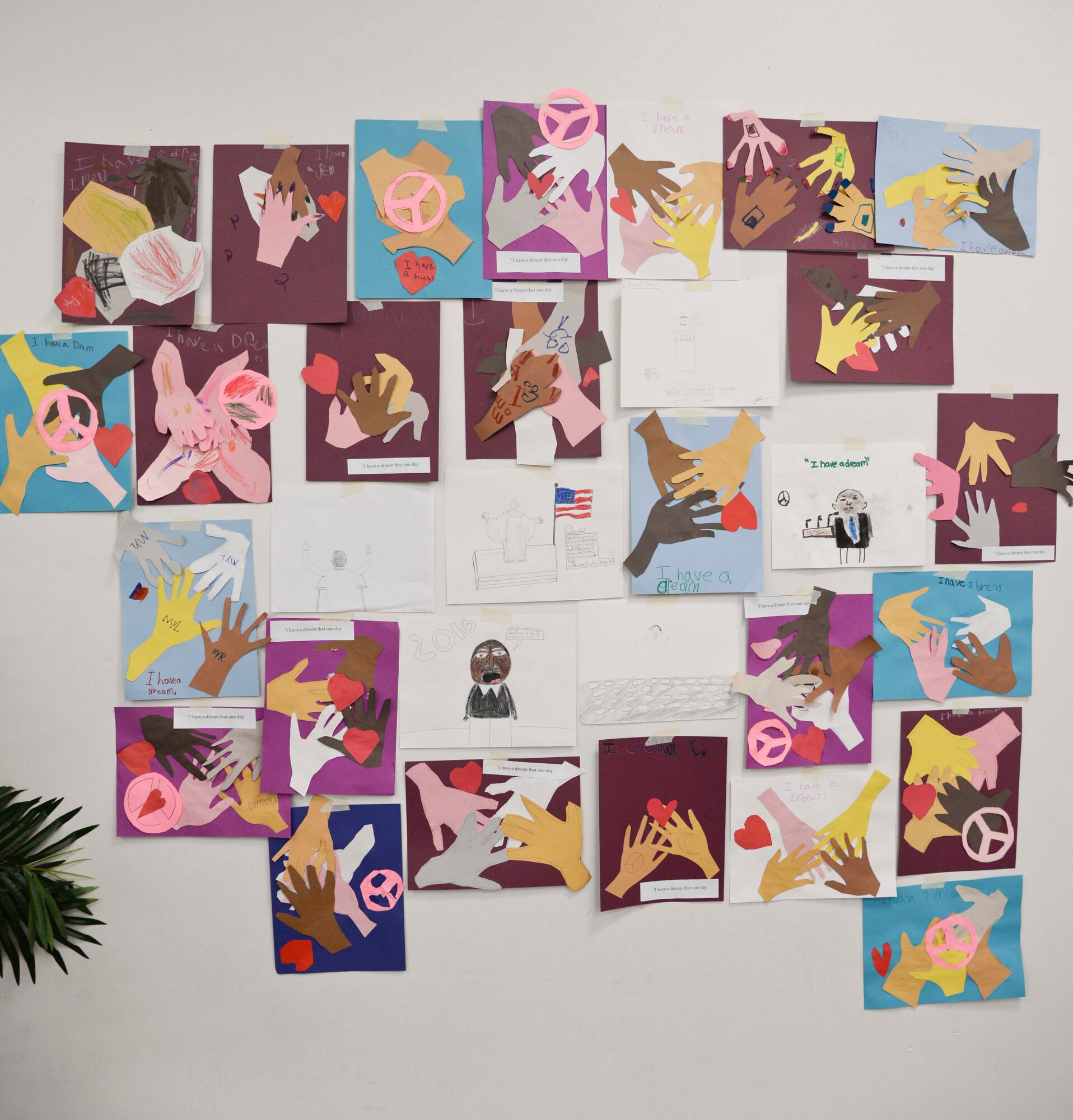Artwork is displayed during a Martin Luther King Jr. Special Observance event at MacDill Air Force Base, Fla., Jan. 15, 2016. Various students from Tinker K-8 submitted artwork showing what they think MLK day represents. (U. S. Air Force photo by Senior Airman Vernon L. Fowler Jr.)