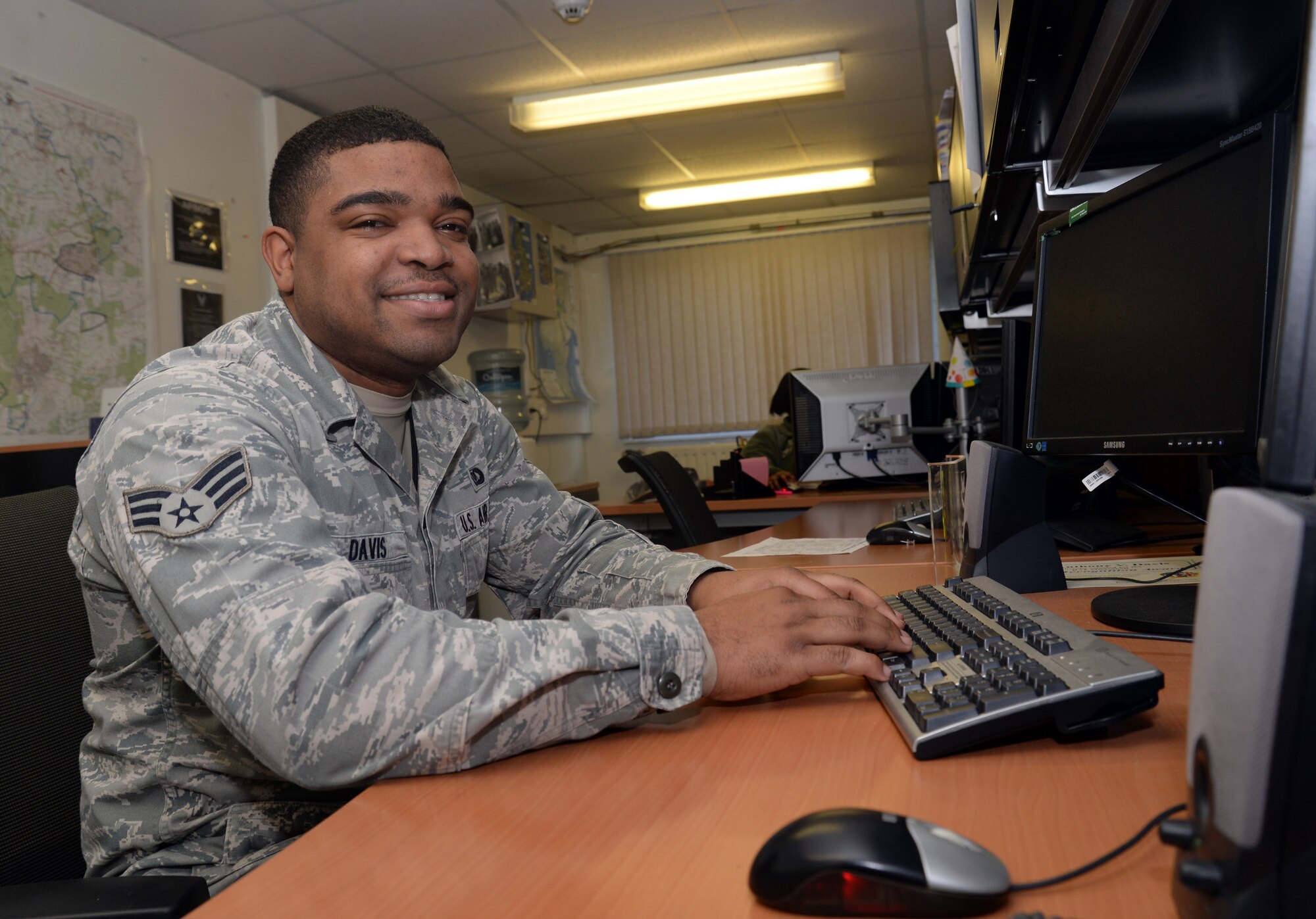 U.S. Air Force Senior Airman Anthony Davis, 352nd Special Operation Support Squadron Joint Air Operations controller, works at his desk, Jan. 13, 2015, on RAF Mildenhall, England. Davis was selected for the Square D Spotlight for portraying the core value of Excellence in All We Do. (U.S. Air Force photo by Senior Airman Christine Halan/Released)