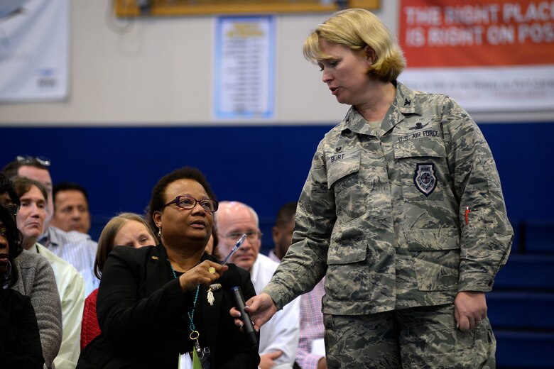 Col. DeAnna M. Burt, 50th Space Wing commander, helps Janice Webb, 50th Space Communications Squadron, submit a question during a town hall for the wing's civilian population Monday, Jan. 11, 2016, in the base fitness center. The meeting was held to present information and address questions regarding the Air Force’s Reduction in Force initiative. (U.S. Air Force Photo/Dennis Rogers)