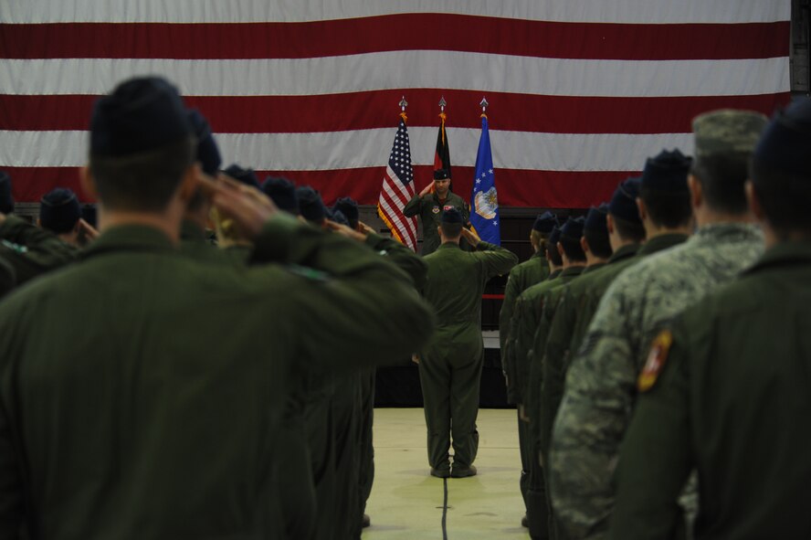 U.S. Air Force Lt. Col. David Berkland, outgoing 480th Fighter Squadron commander, renders his final salute to his squadron before relinquishing command during a change of command ceremony at Hangar One on Spangdahlem Air Base, Germany, Jan. 15, 2016. The ceremony traditionally includes the outgoing commander to offer their final salute and for the incoming commander to offer their first. (U.S. Air Force photo by Staff Sgt. Joe W. McFadden/Released)