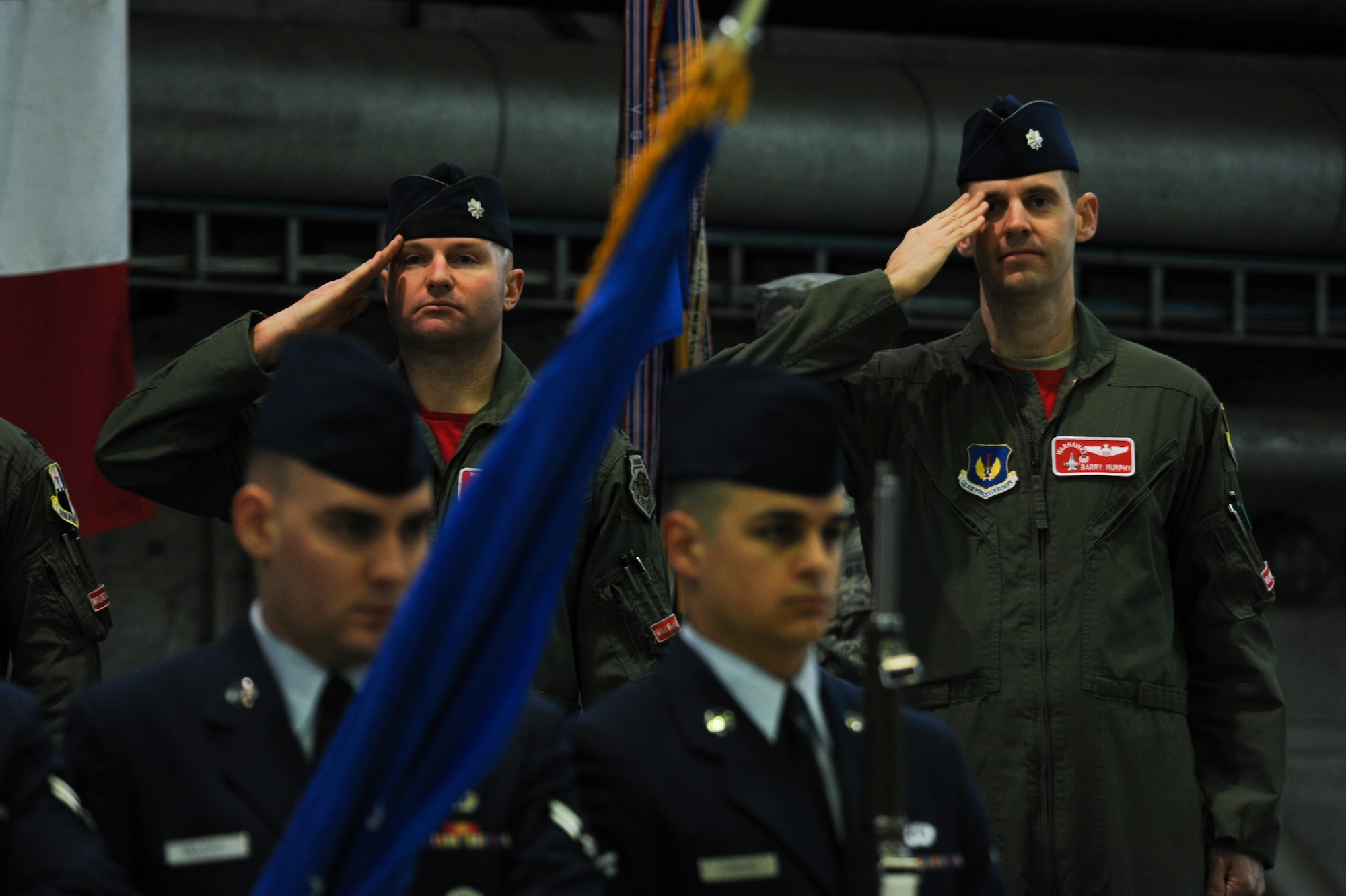 U.S. Air Force Lt. Col. David Berkland, outgoing 480th Fighter Squadron commander, left, and U.S. Air Force Lt. Col. Timothy Murphy, incoming 480th FS commander, salute during the playing of the national anthems during a change of command ceremony at Hangar One on Spangdahlem Air Base, Germany, Jan. 15, 2016. Berkland relinquished command to Murphy after serving as the squadron commander since January 2014. (U.S. Air Force photo by Staff Sgt. Joe W. McFadden/Released)