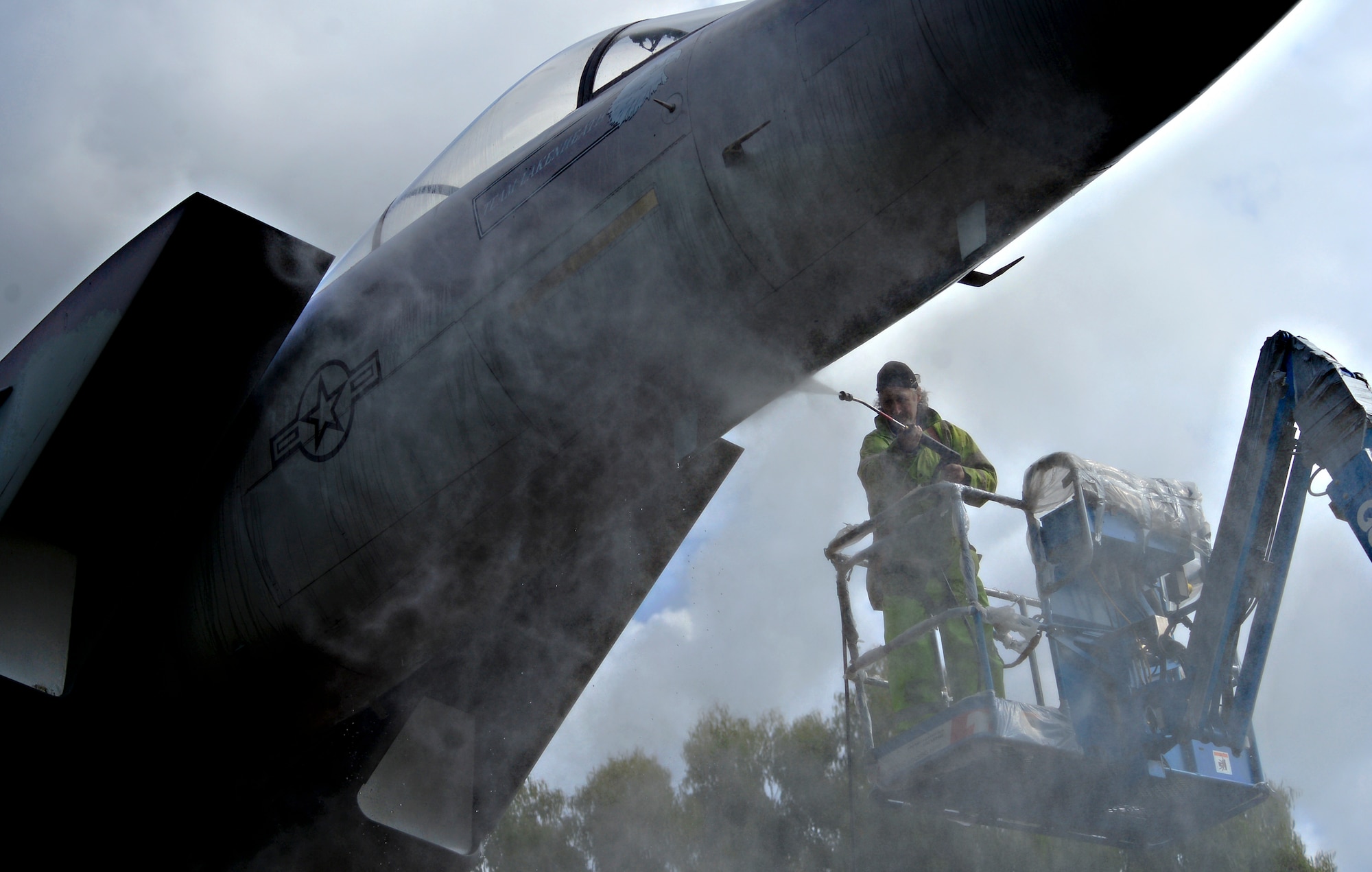 Workers from Fangeos Painting and Decorating Contractors in Essex pressure wash the static displays before repainting them at Royal Air Force Lakenheath, England, July 22, 2015. Working with the local community is vital in accomplishing the mission of the 48th Fighter Wing. (U.S. Air Force photo by Senior Airman Erin Trower/Released) 