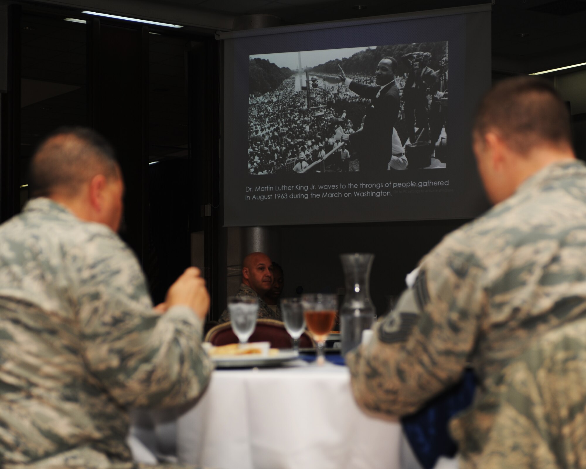 Participants eat lunch and discuss Dr. Martin Luther King, Jr’s contribution to the civil rights movement during a special observance day luncheon Jan. 14, 2015, at Incirlik Air Base, Turkey. During the luncheon a slideshow containing facts and photos was presented to the audience.  (U.S. Air Force photo by Airman 1st Class Daniel Lile/Released)