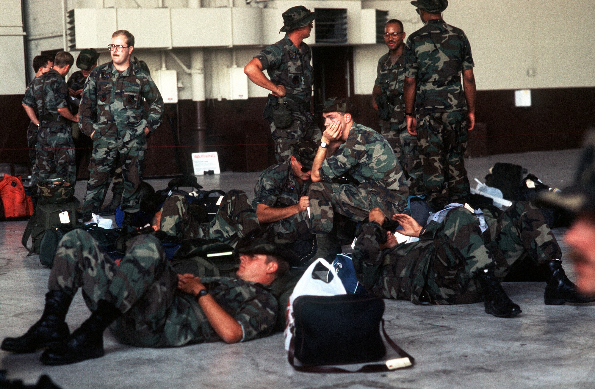 Support personnel of the 388th Tactical Fighter Wing wait to board an aircraft for a flight to Saudi Arabia to take part in Operation Desert Shield. (U.S. Air Force photo)     