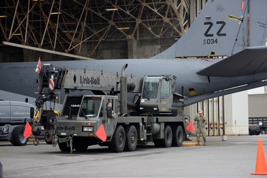 U.S Navy Equipment Operator 3rd Class Zachary Williams and EO 3rd Class Aaron Talosig, Naval Mobile Construction Battalion 3 Seabees construction men, maneuver a Link Belt 40-ton crane into position Jan. 14, 2016, at Kadena Air Base, Japan. The Seabees arrived on scene with a specialized crane to enable U.S. Air Force maintainers to lift off the tail section of a KC-135 Stratotanker for rudder repairs. (U.S. Air Force photo by Senior Airman Peter Reft)