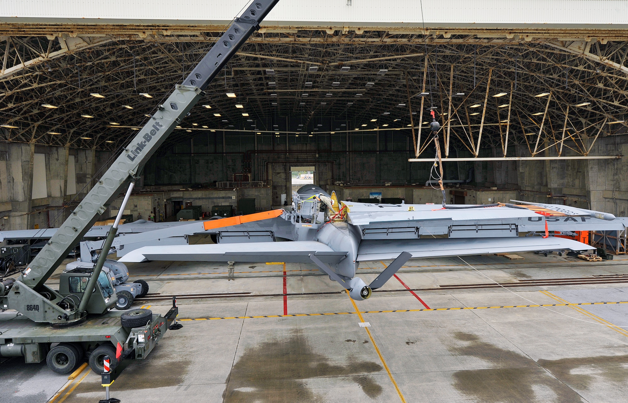 Members of the 18th Aircraft Maintenance Squadron and U.S. Navy Naval Mobile Construction Battalion 3 Seabees conduct rudder removal on the KC-135 Stratotanker, Jan. 14, 2016, at Kadena Air Base, Japan. Navy Seabees provided a 40-ton crane to remove a rudder on a KC-135 Stratotanker to ensure the mission readiness of the KC-135 Stratotanker’s mission. (U.S. Air Force photo by Naoto Anazawa)