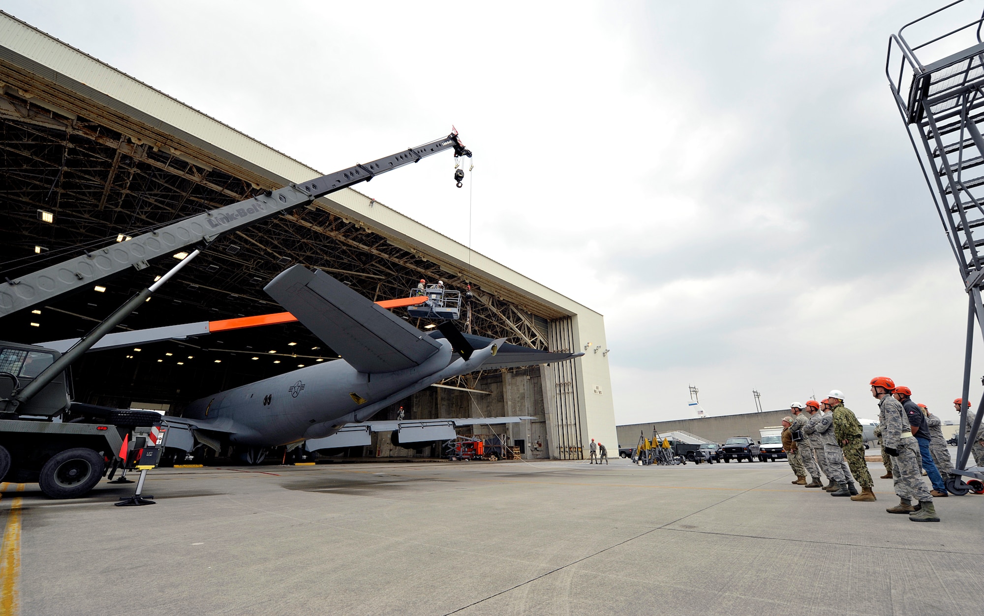 Airmen from the 18th Aircraft Maintenance Squadron and U.S. Navy Naval Mobile Construction Battalion 3 Seabees members supervise the rudder removal on a KC-135 Stratotanker, Jan. 14, 2016, at Kadena Air Base, Japan. The KC-135 Stratotanker rudder is used to control the yaw of the aircraft from side to side. (U.S. Air Force photo by Naoto Anazawa)