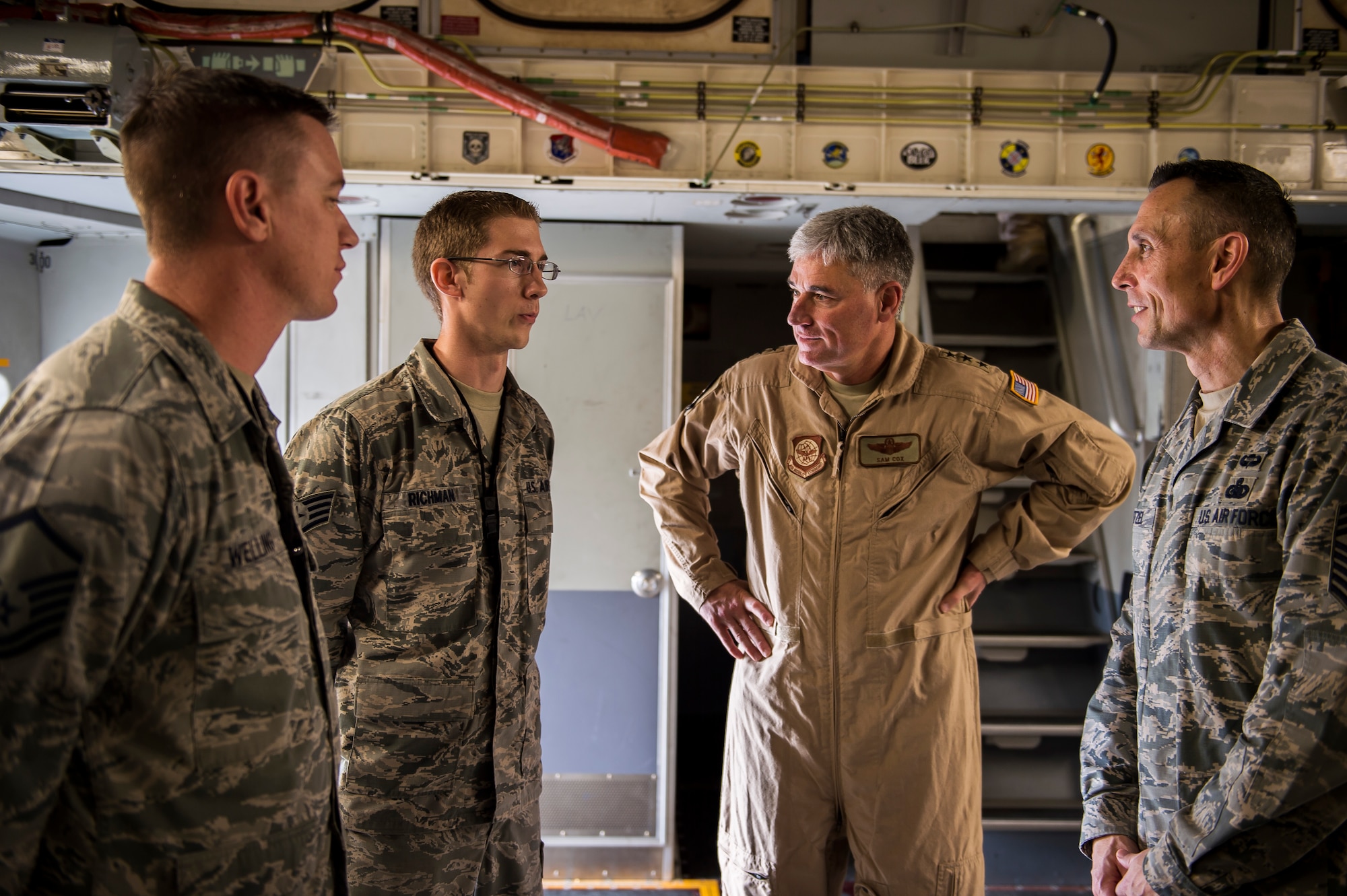 Staff Sgt. Cody Richman, 437th Aircraft Maintenance Squadron crew chief, speaks to Lt. Gen. Sam Cox, 18th Air Force commander and Chief Master Sgt. Todd Petzel, 18th AF command chief, aboard a C-17 Globemaster III before departing on a mission Dec. 30, 2015, at Joint Base Charleston, S.C. Cox traveled to Joint Base McGuire-Dix-Lakehurst, N.J.; Ramstein Air Base, Germany; Incirlik Air Base, Turkey; and Al Udeid Air Base, Qatar, to get first-hand experience of the challenges mobility Airmen face in the U.S. Central Command area of operations. (U.S. Air Force photo/Senior Airman Jared Trimarchi)