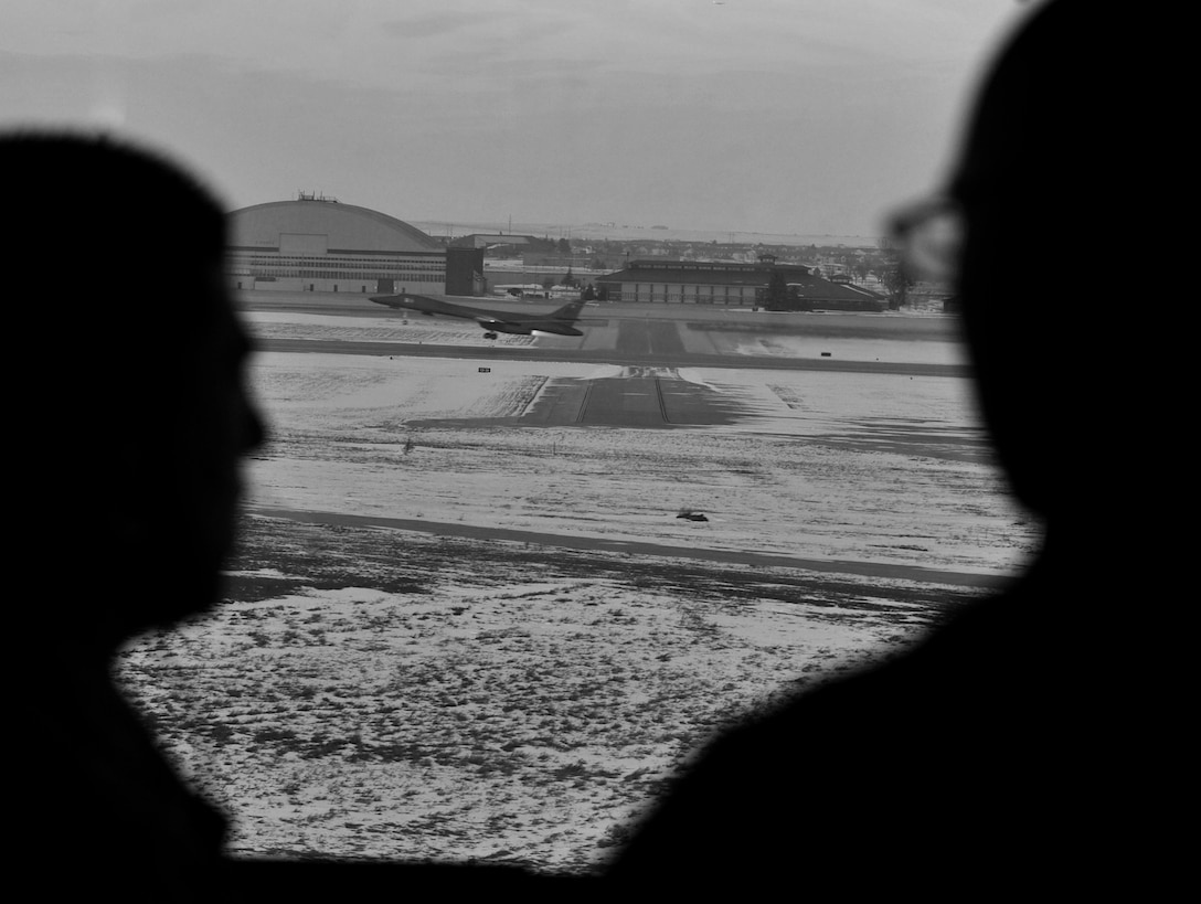 A B-1 bomber performs a ‘touch and go’ as two air traffic controllers communicate with the aircrew to ensure the take-off goes smoothly at Ellsworth Air Force Base, S.D., Jan. 6, 2016. It takes a team of air traffic controllers to coordinate all aspects of flight operations, from taking off in clear airspace to landing on the runway. Air traffic controllers coordinate approximately 25 sorties a week, keeping pilots prepared for contingency operations. (U.S. Air Force photo illustration by Airman 1st Class James L. Miller/Released)