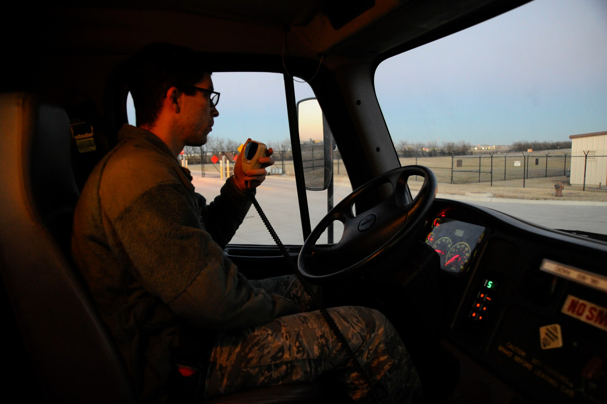 Airman 1st Class Zachary Smith, 22nd Logistics Readiness Squadron fuels distribution, provides a job status updates, Jan. 14, 2016, at McConnell Air Force Base, Kan. The fuels distribution Airmen are responsible for inspecting and maintaining the vehicle refueling fleet to ensure mission readiness. (U.S. Air Force photo/Airman Jenna K. Caldwell) 