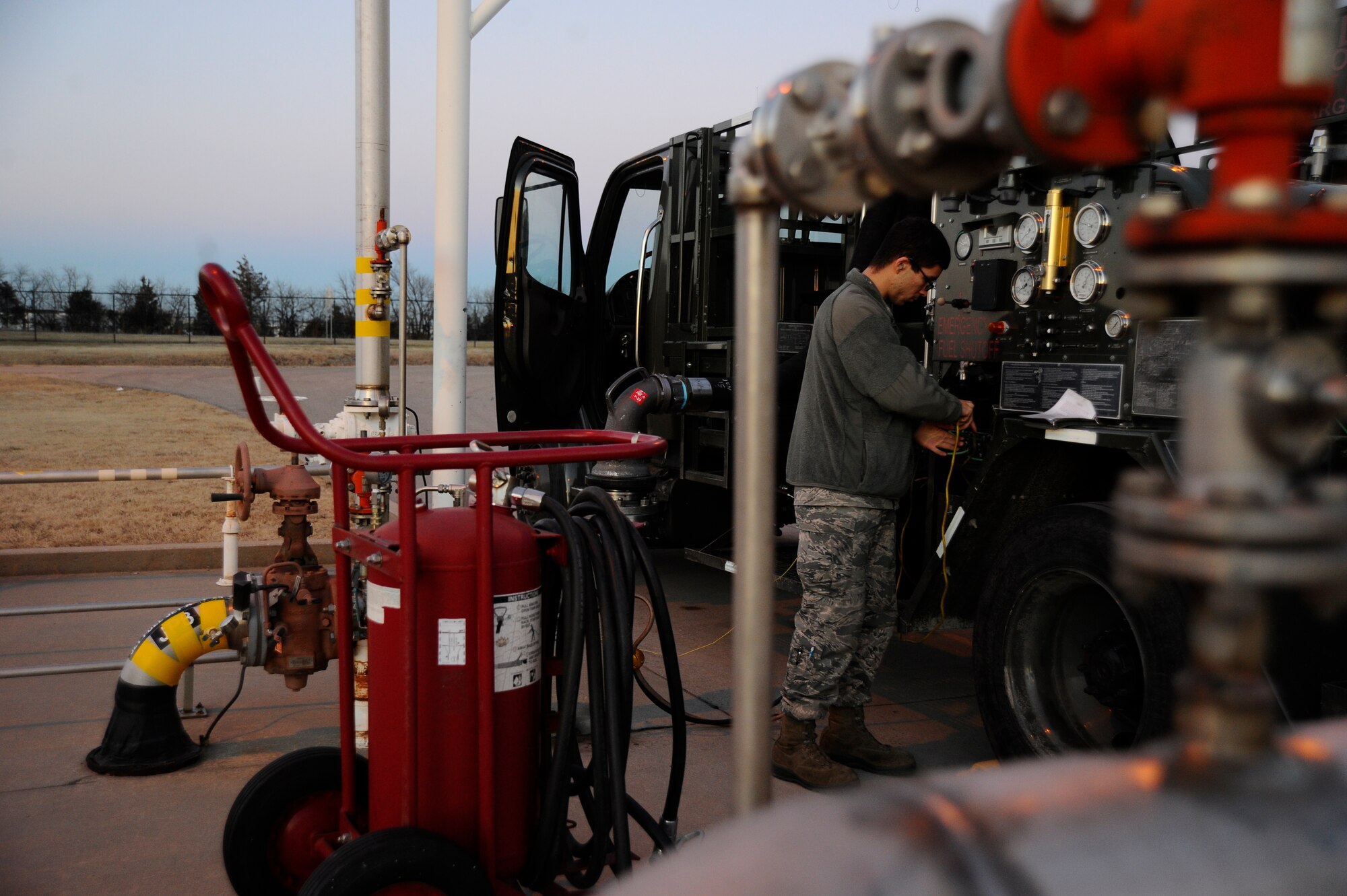 Airman 1st Class Zachary Smith, 22nd Logistics Readiness Squadron fuels distribution, hooks up a vehicle to a fuel distribution test stand, Jan. 14, 2016, at McConnell Air Force Base, Kan. When fuels distribution Airmen are not on the flightline refueling the KC-135 Stratotanker, they inspect and maintain the vehicle fleet for mission readiness. (U.S. Air Force photo/Airman Jenna K. Caldwell) 