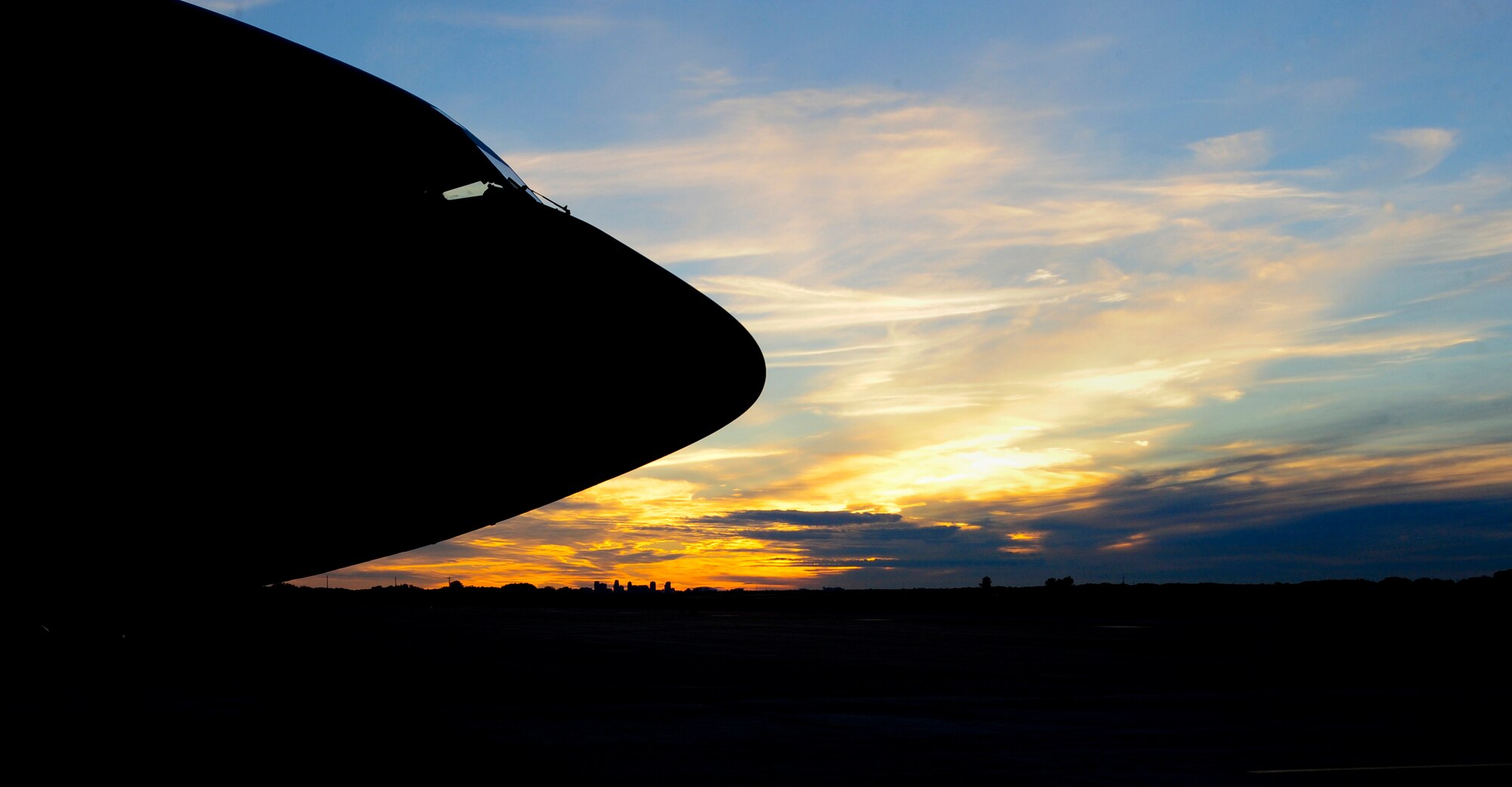 A KC-135 Stratotanker sits on the flightline at MacDill Air Force Base, Fla., as the sun sets over St. Petersburg, Fla. on Jan. 12, 2015. The 16 KC-135 Stratotankers currently assigned to MacDill provide aerial refueling to nine combatant commands. (U.S. Air force photo by Airman 1st Class Mariette M. Adams)